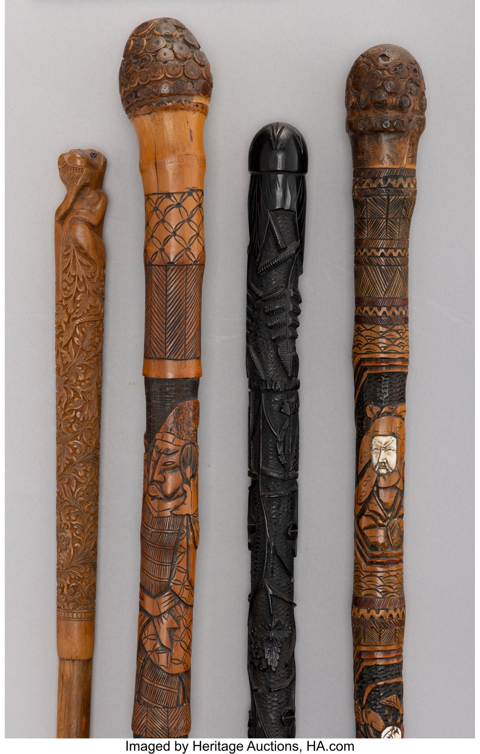 Four Carved Bamboo and Ebonized Wood Canes, circ (1 of 4)