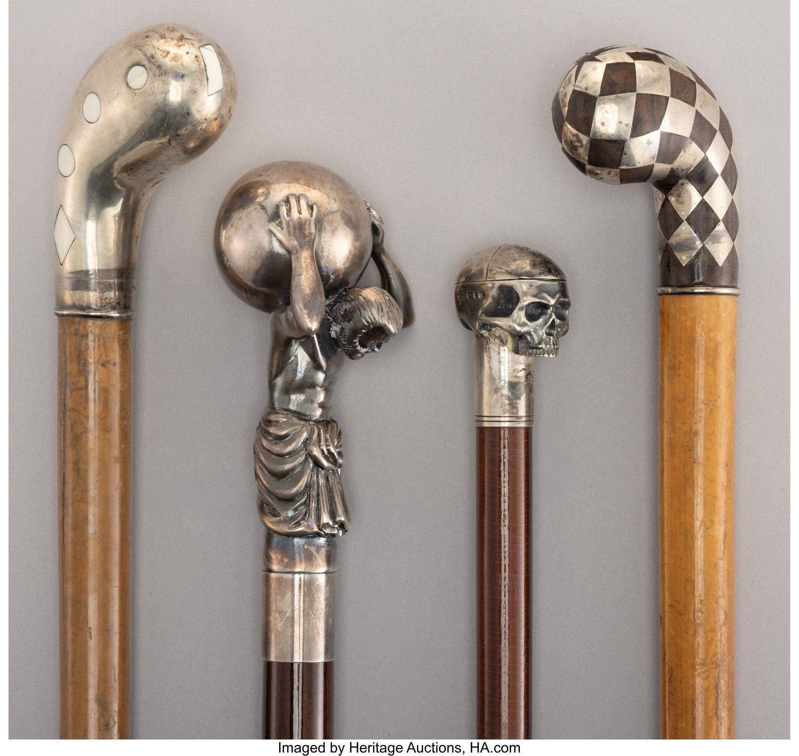 A Group of Four Silver-Mounted Wood Canes Marks: A Group of Four Silver-Mounted Wood Canes Marks to largest: R, .925, Gr. 1.0 38-3/4 x 2-1/2 inches (98.4 x 6.3 cm) (largest&