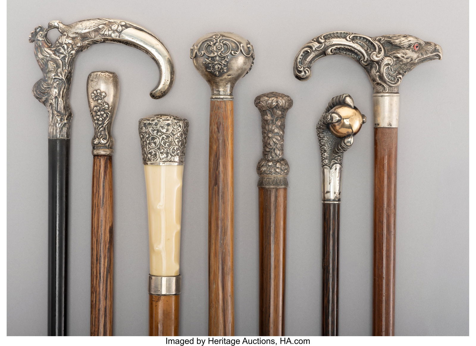 A Collection of Seven Silver-Mounted, Carved Woo: A Collection of Seven Silver-Mounted, Carved Wood, and Bamboo Canes, circa 1893 and later Marks to tallest: (lion-anchor-G), STERLING, D638 37-1/2 x 2
