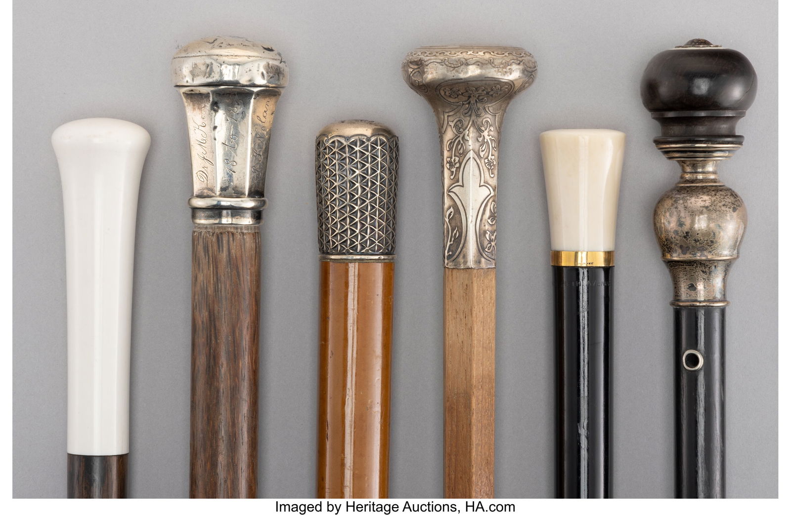 Six 18k Gold, Silver-Mounted, and Carved Wood Ca: Six 18k Gold, Silver-Mounted, and Carved Wood Canes, circa 1900 38 x 1-1/4 inches (96.5 x 3.2 cm) (tallest) HID03101062020 © 2026 Heritage