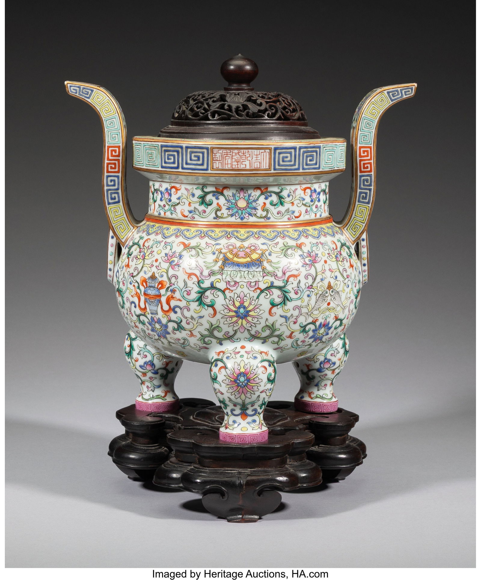 A Chinese Famille Rose Tripod Censer with Carved: A Chinese Famille Rose Tripod Censer with Carved Wood Cover and Stand, Qing dynasty Marks: (six-character Qianlong mark) 14 x 10-3/4 x 7-1/8 inches (35.6 x 27