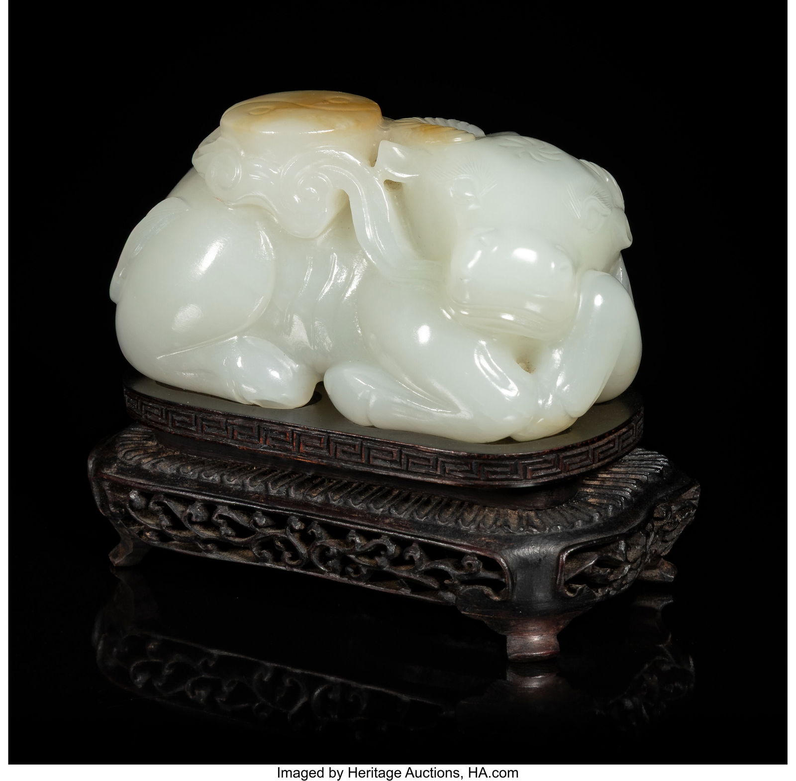 A Chinese Carved Russet and White Jade Figure of: A Chinese Carved Russet and White Jade Figure of a Recumbent Buffalo, 20th century 2 x 3-1/2 x 2-1/4 inches (5.1 x 8.9 x 5.7 cm) (work) carved as