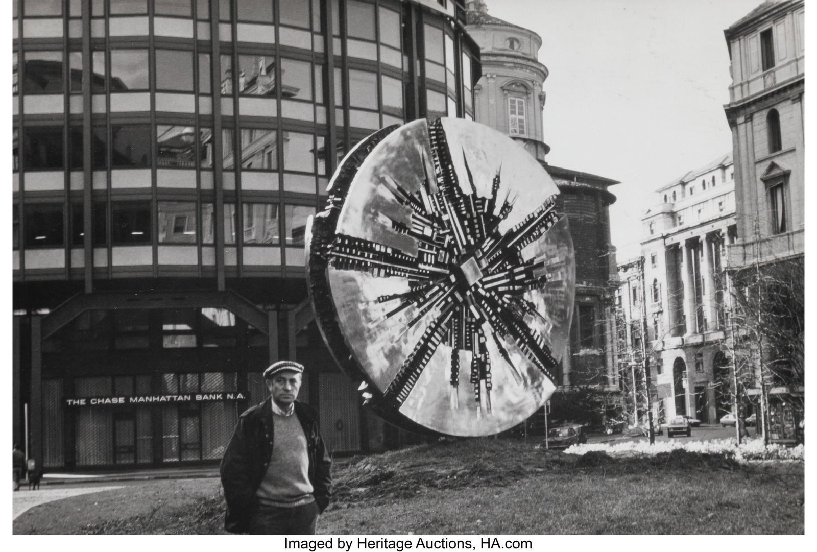 Anonymous (20th Century) Arnoldo Pomodoro and Hi: Anonymous (20th Century) Arnoldo Pomodoro and His "Grande Disco", Piazza Filippo Meda, Milan, 1978 Gelatin silver print, printed circa March 1981 6-3/8 x 9-3/