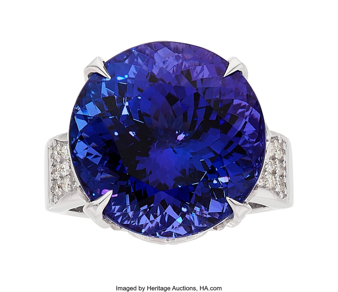 Tanzanite, Diamond, White Gold Ring Stones: Ro: Tanzanite, Diamond, White Gold Ring Stones: Round-shaped tanzanite weighing 23.80 carats; full-cut diamonds weighing a total of 0.53 carat Metal: 18k white g