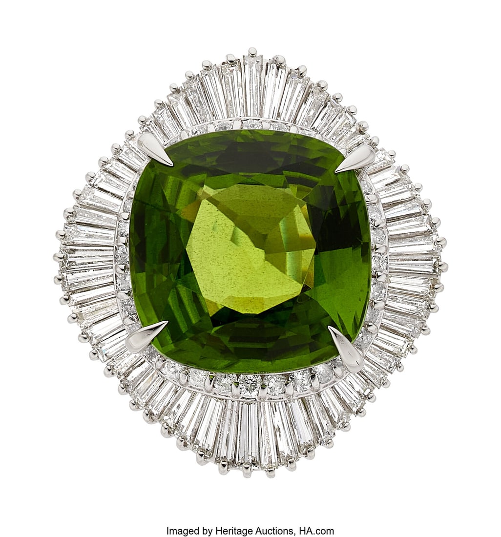 Peridot, Diamond, Platinum Ring Stones: Cushion: Peridot, Diamond, Platinum Ring Stones: Cushion-shaped peridot weighing 26.31 carats; baguette and full-cut diamonds weighing a total of 4.31 carats Metal: P