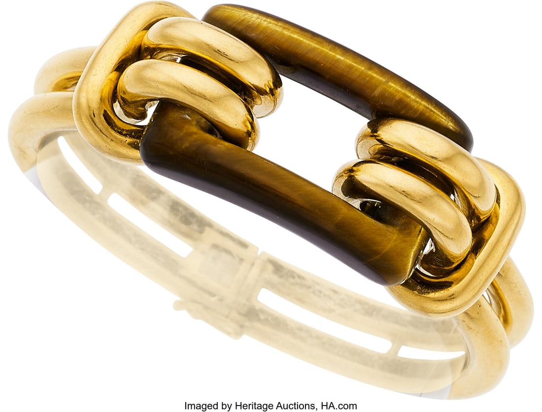 Tiger's-Eye Quartz, Gold Bracelet Stones: Carve: Tiger's-Eye Quartz, Gold Bracelet Stones: Carved tiger's-eye quartz Metal: 18k gold Gross Weight: 64.30 grams Dimensions: 6-1/4 inches x 3/4 inch HID031010