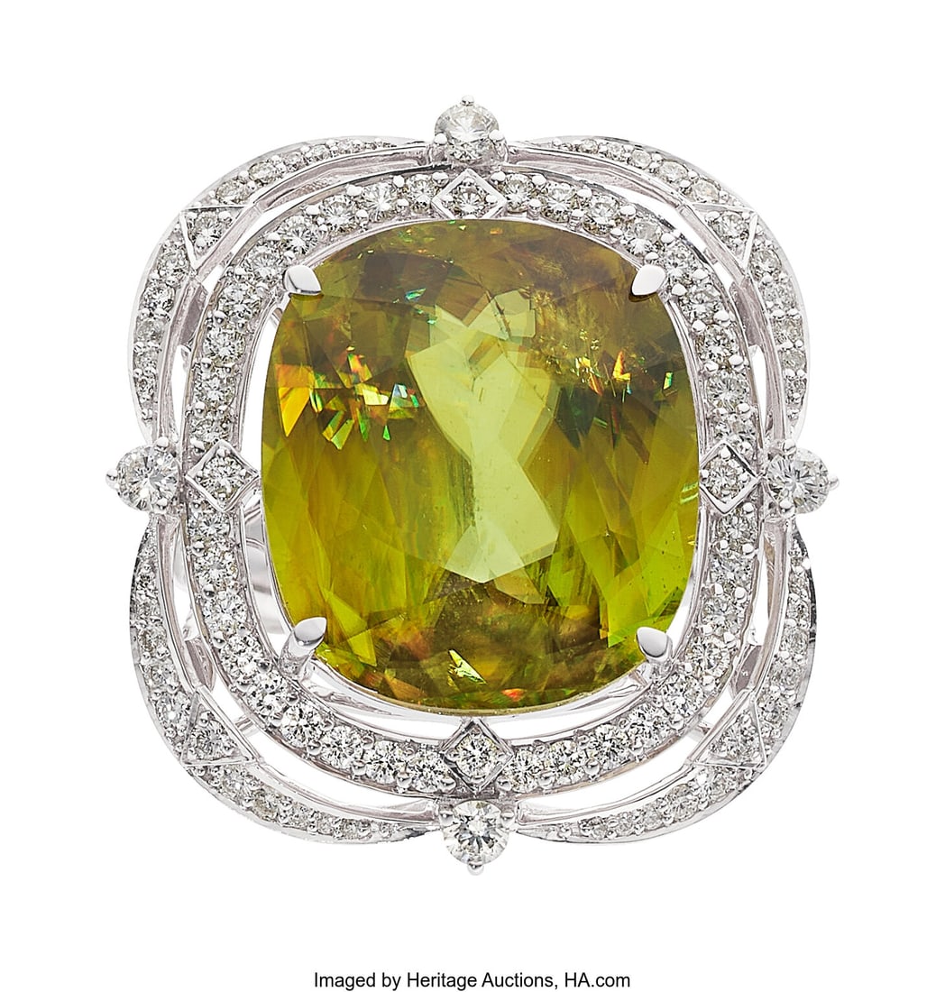 Sphene, Diamond, White Gold Ring Stones: Cushio: Sphene, Diamond, White Gold Ring Stones: Cushion-shaped sphene weighing 21.87 carats; full-cut diamonds weighing a total of 1.50 carats Metal: 18k white gold