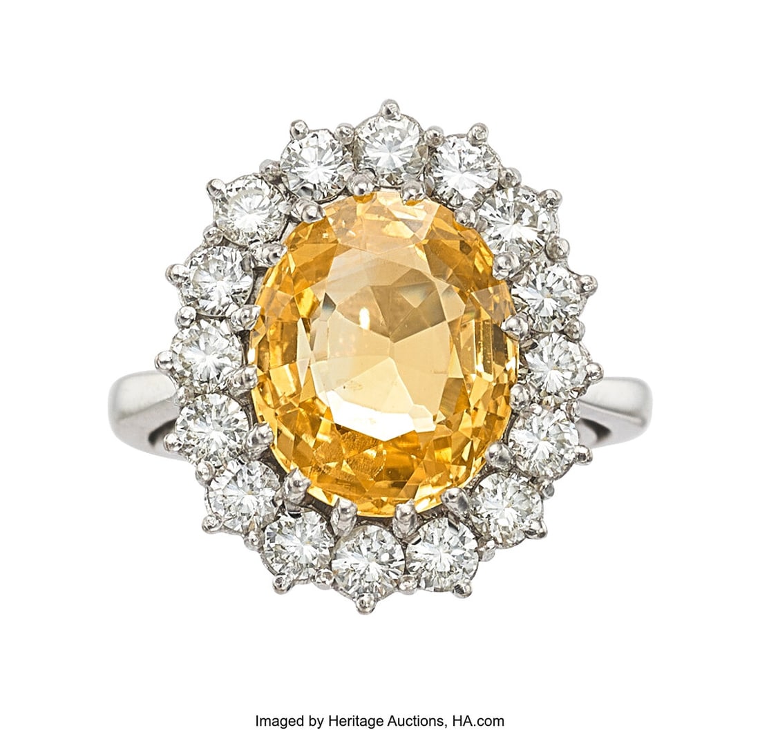 Ceylon Yellow Sapphire, Diamond, White Gold Ring: Ceylon Yellow Sapphire, Diamond, White Gold Ring, circa 1987 Stones: Oval-shaped sapphire weighing approximately 5.00 carats; full-cut diamonds weighing a