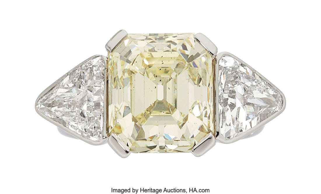 Diamond, Platinum Ring Stones: Emerald-cut diam: Diamond, Platinum Ring Stones: Emerald-cut diamond weighing 6.52 carats; triangular-shaped diamonds weighing a total of approximately 1.75 carats Metal: Platinum G
