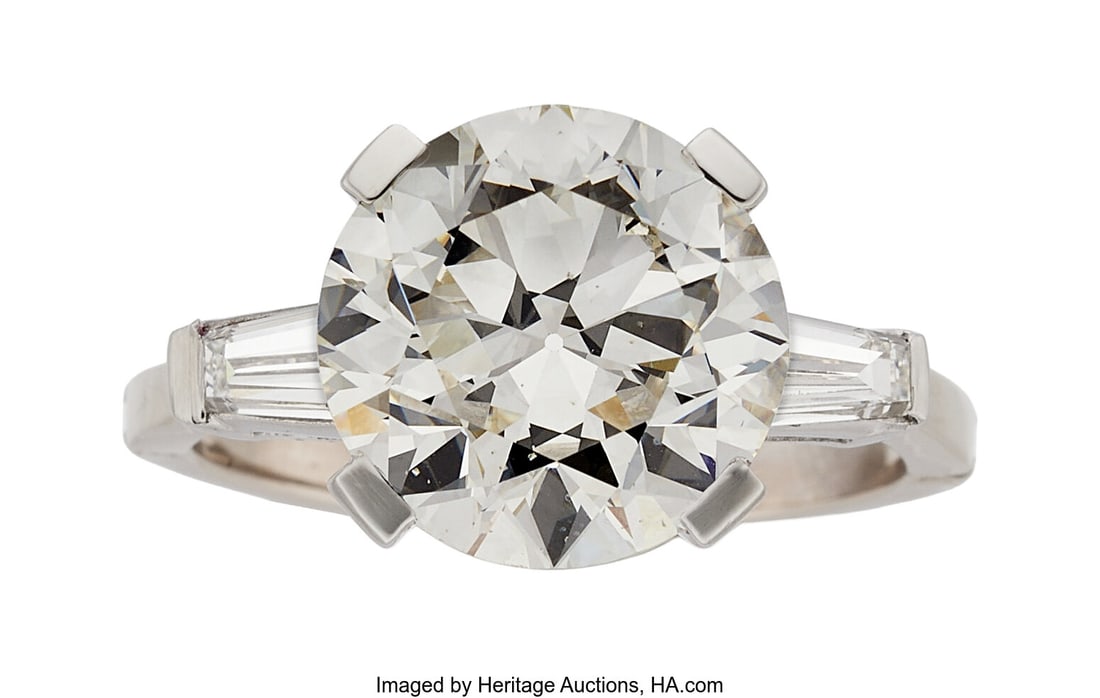 Diamond, White Gold Ring Stones: Circular brill: Diamond, White Gold Ring Stones: Circular brilliant-cut diamond weighing 6.23 carats; tapered baguette-cut diamonds weighing a total of approximately 0.45 carat Metal&co