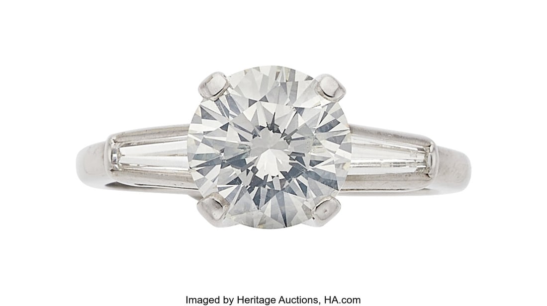 Diamond, Platinum Ring Stones: Round brilliant-: Diamond, Platinum Ring Stones: Round brilliant-cut diamond weighing 2.13 carats; baguette-cut diamonds weighing a total of approximately 0.50 carat Metal: Platinum