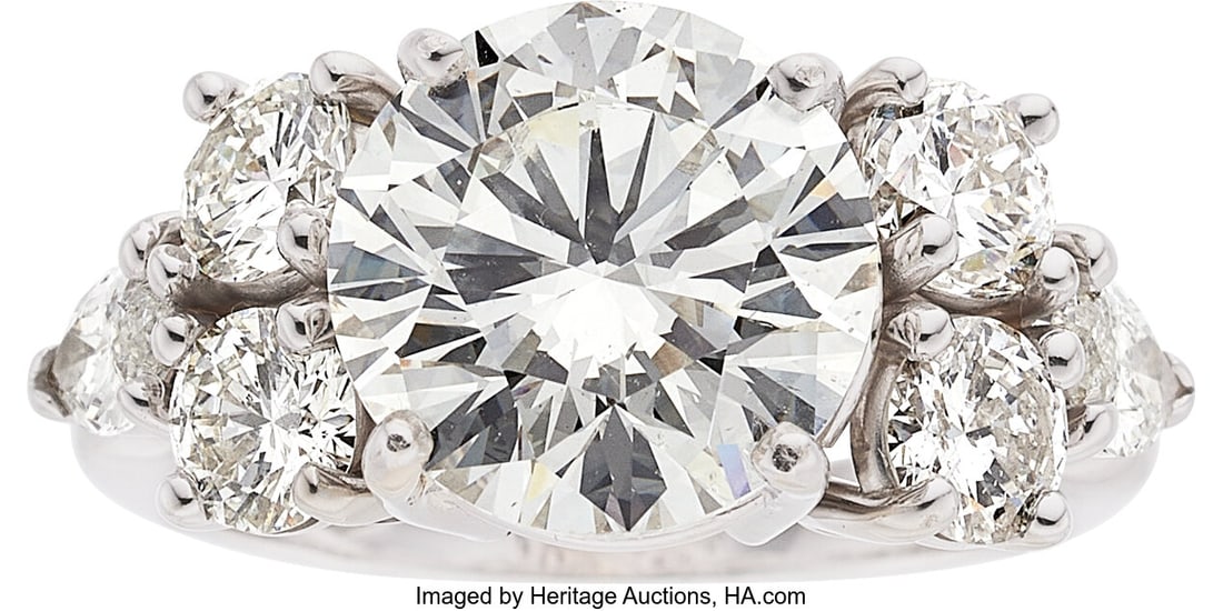 Diamond, White Gold Ring Stones: Round brillian: Diamond, White Gold Ring Stones: Round brilliant-cut diamond weighing 5.03 carats; full-cut diamonds weighing a total of approximately 1.40 carats; marquise-shaped