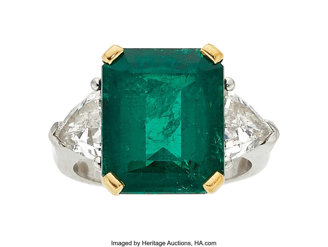 Colombian Emerald, Diamond, Platinum, Gold Ring: Colombian Emerald, Diamond, Platinum, Gold Ring Stones: Emerald-cut emerald weighing approximately 6.75 carats; triangular-shaped diamonds weighing a total of appro