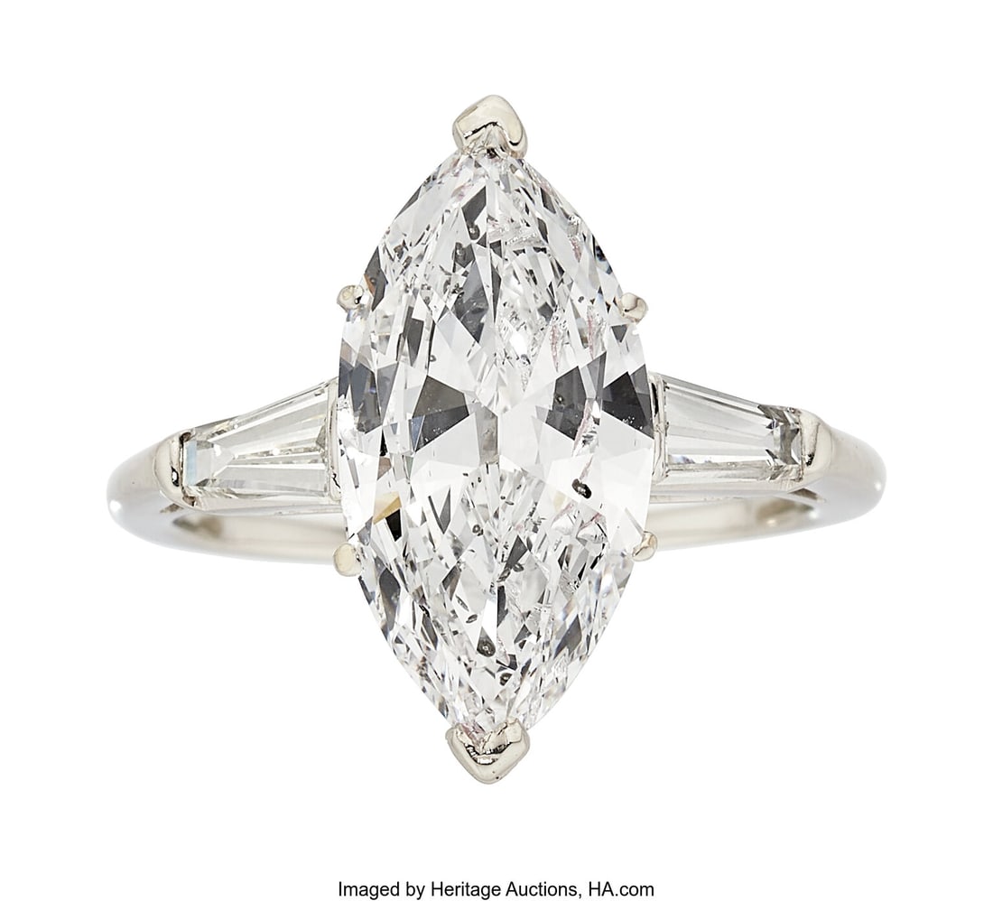 Diamond, Platinum Ring Stones: Marquise-shaped: Diamond, Platinum Ring Stones: Marquise-shaped diamond weighing 4.28 carats; baguette-cut diamonds weighing a total of approximately 0.50 carat Metal: Platinum Gro