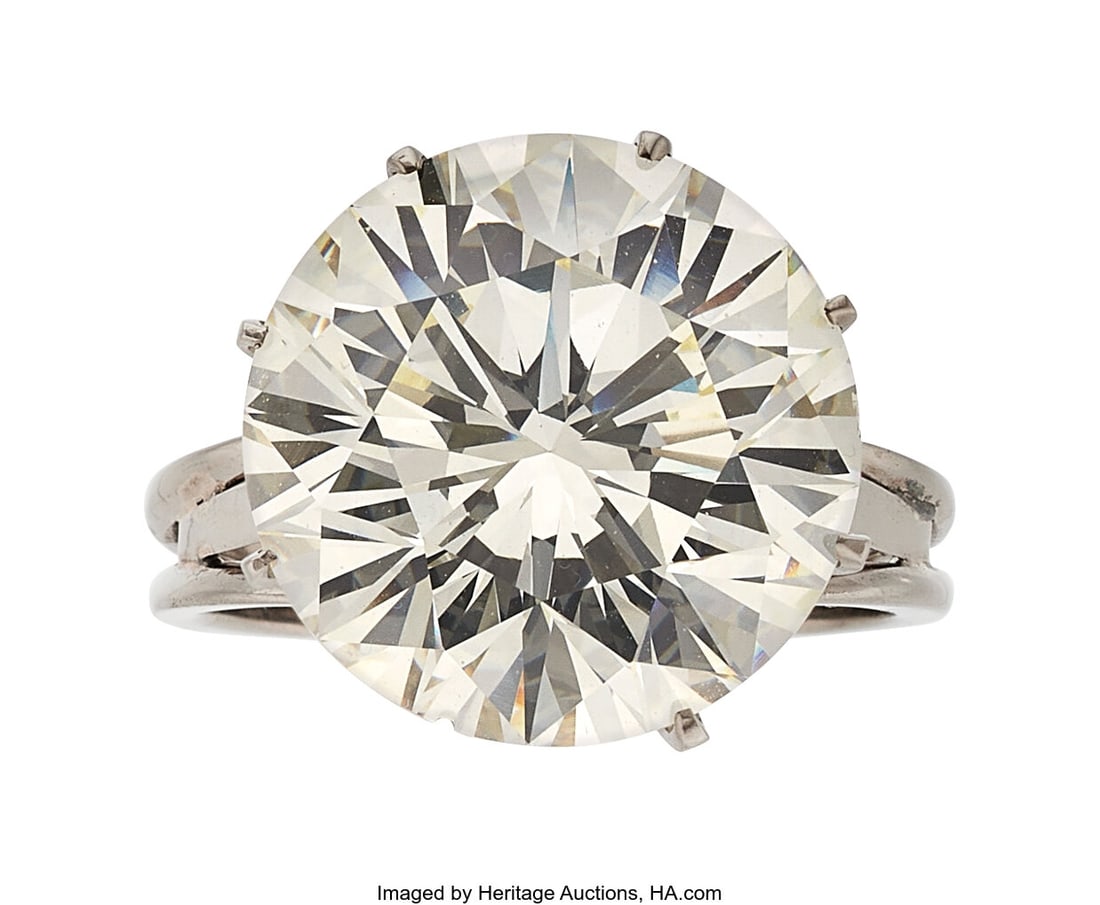 Diamond, White Gold Ring Stones: Round brillian: Diamond, White Gold Ring Stones: Round brilliant-cut diamond weighing 12.90 carats Metal: 18k white gold Gross Weight: 8.50 grams Size: 7 (sizeable&rpa