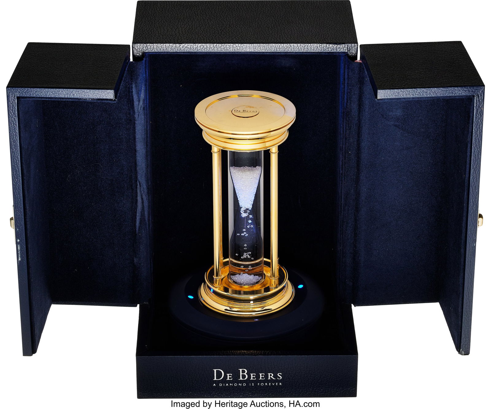 De Beers Diamond, Gold Plated Brass Hourglass, c: De Beers Diamond, Gold Plated Brass Hourglass, circa 2000 Stones: Natural octahedral diamonds Element: Glass Metal: Gold plated brass Marked: De Beers Gross Weight&