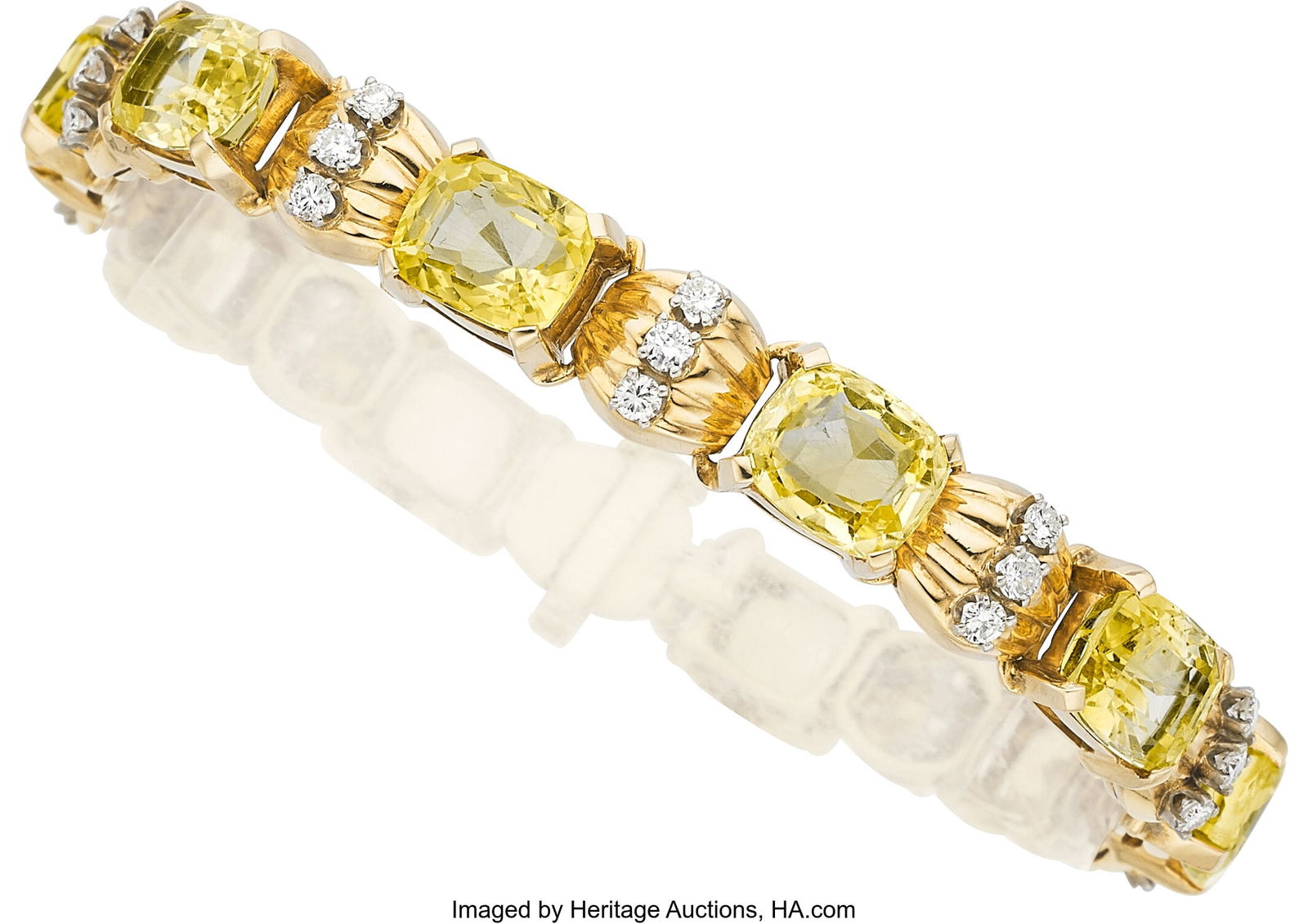 Ceylon Yellow Sapphire, Diamond, Gold, Palladiu: Ceylon Yellow Sapphire, Diamond, Gold, Palladium Bracelet Stones: Cushion-shaped yellow sapphires weighing a total of approximately 30.00 carats; full-cut diamonds
