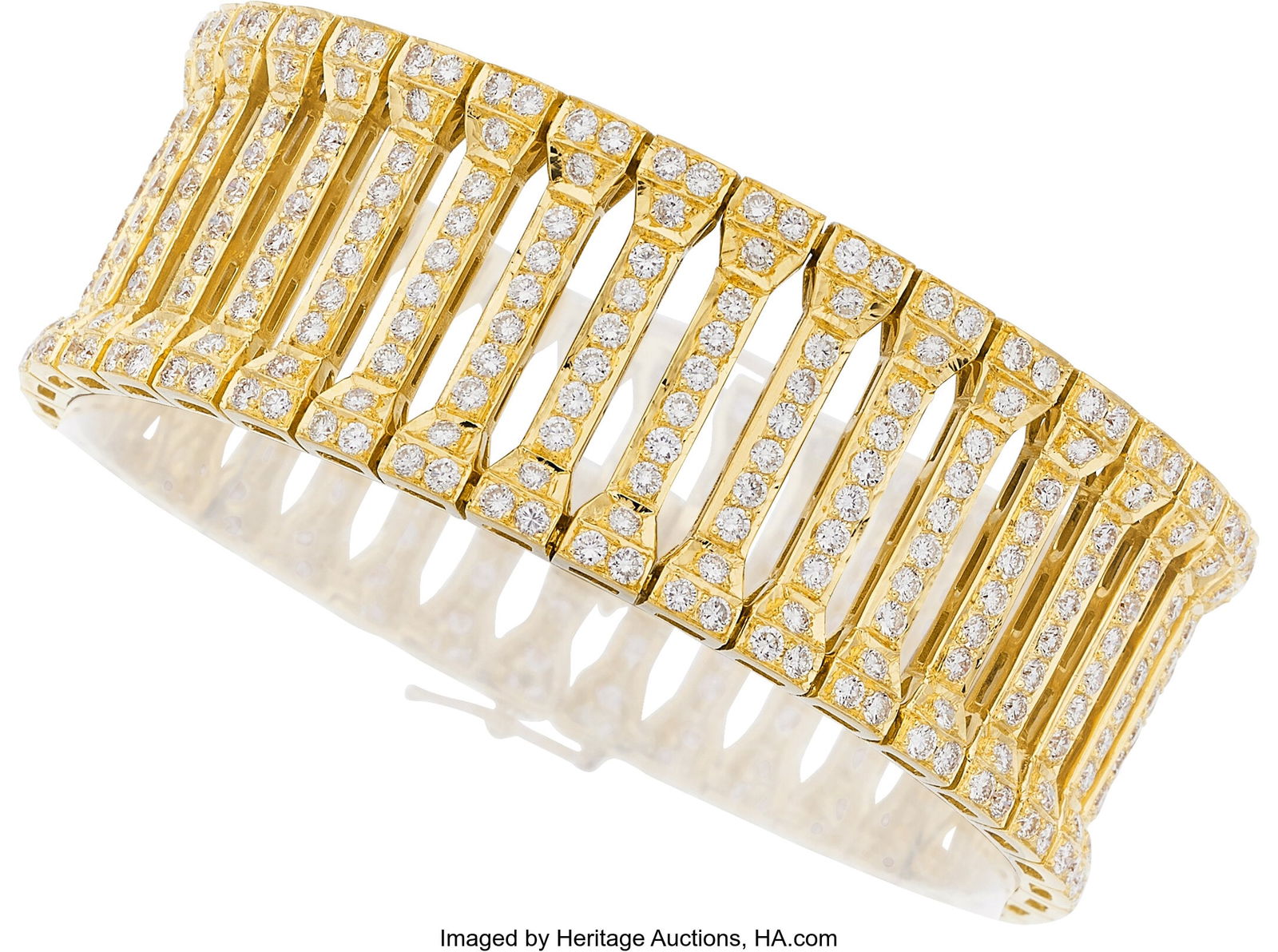 Diamond, Gold Bracelet Stones: Full-cut diamond: Diamond, Gold Bracelet Stones: Full-cut diamonds weighing a total of approximately 9.00 carats Metal: 18k gold Gross Weight: 69.00 grams Dimensions: 7 inche