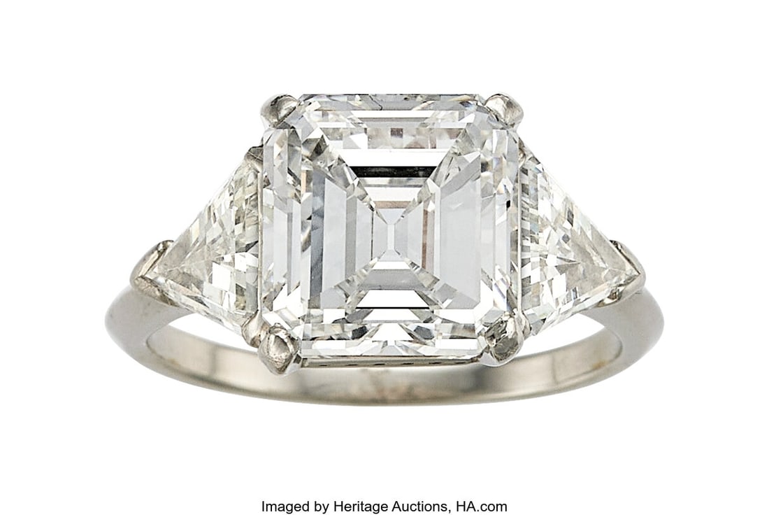 Diamond, Platinum Ring Stones: Emerald-cut diam: Diamond, Platinum Ring Stones: Emerald-cut diamond weighing 4.71 carats; calf's head-cut diamonds weighing a total of approximately 2.00 carats Metal: Platinum Gro
