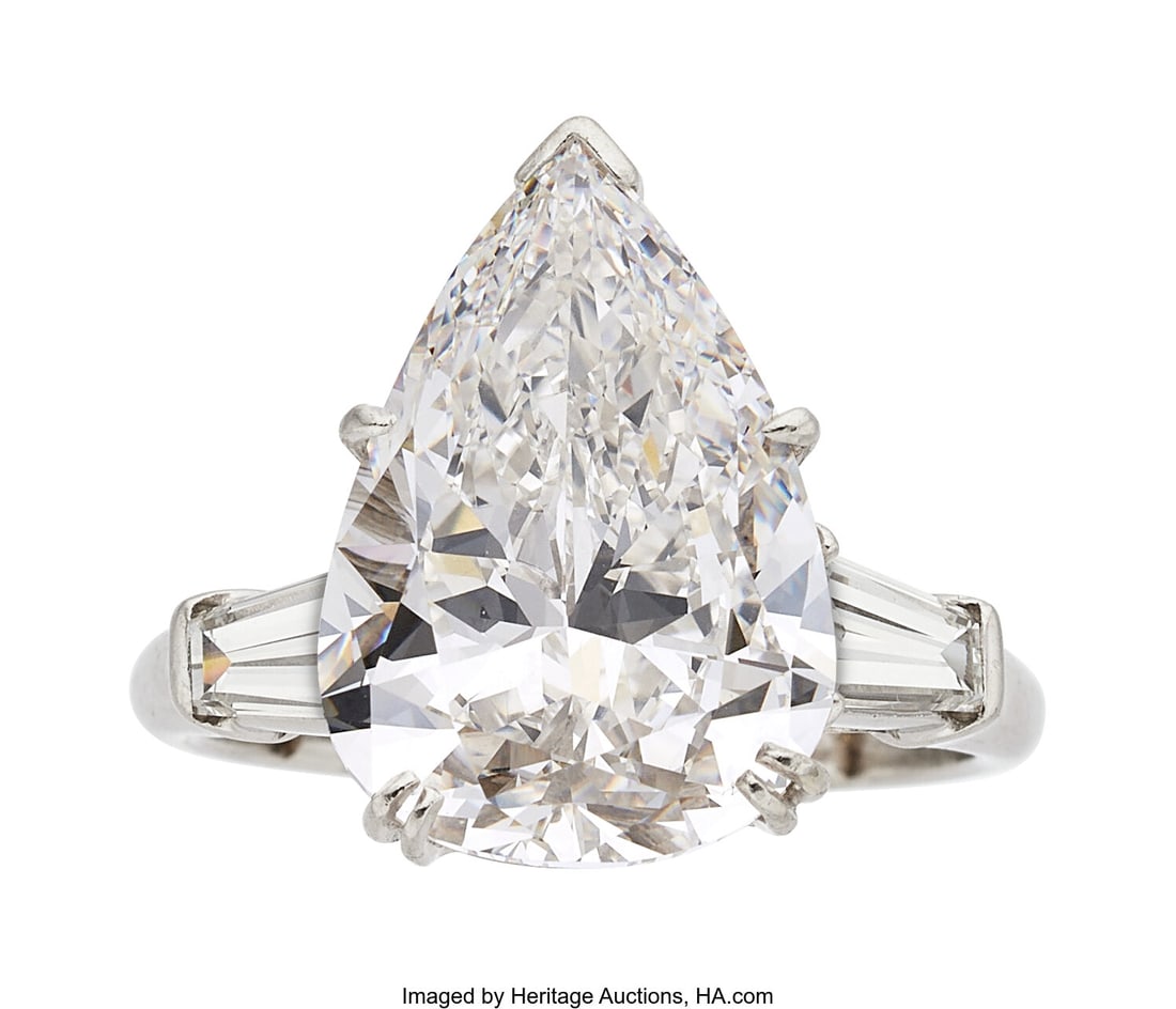 Diamond, Platinum Ring Stones: Pear-shaped diam: Diamond, Platinum Ring Stones: Pear-shaped diamond weighing 7.50 carats; tapered baguette-cut diamonds weighing a total of approximately 0.80 carat Metal: Platinum