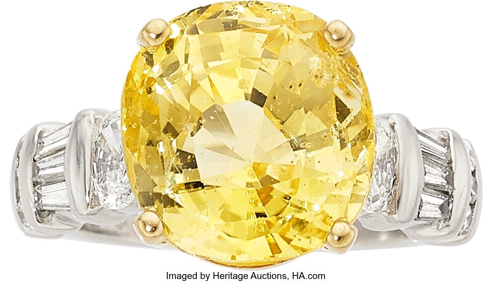 Yellow Sapphire, Diamond, Platinum, Gold Ring S: Yellow Sapphire, Diamond, Platinum, Gold Ring Stones: Cushion-shaped yellow sapphire weighing approximately 10.50 carats; oval-shaped diamonds weighing a total of a
