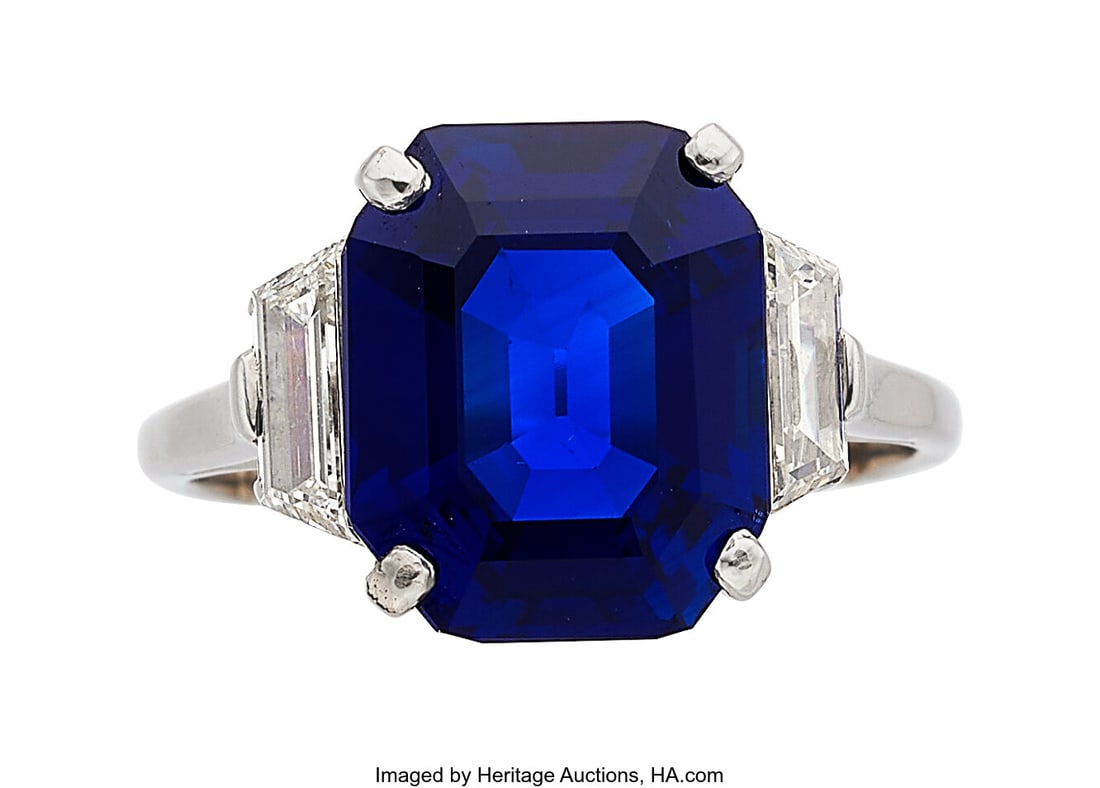 Kashmir Sapphire, Diamond, Platinum Ring Stones: Kashmir Sapphire, Diamond, Platinum Ring Stones: Octagonal-shaped sapphire weighing 6.59 carats; trapezoid-shaped diamonds weighing a total of approximately 1.00 c