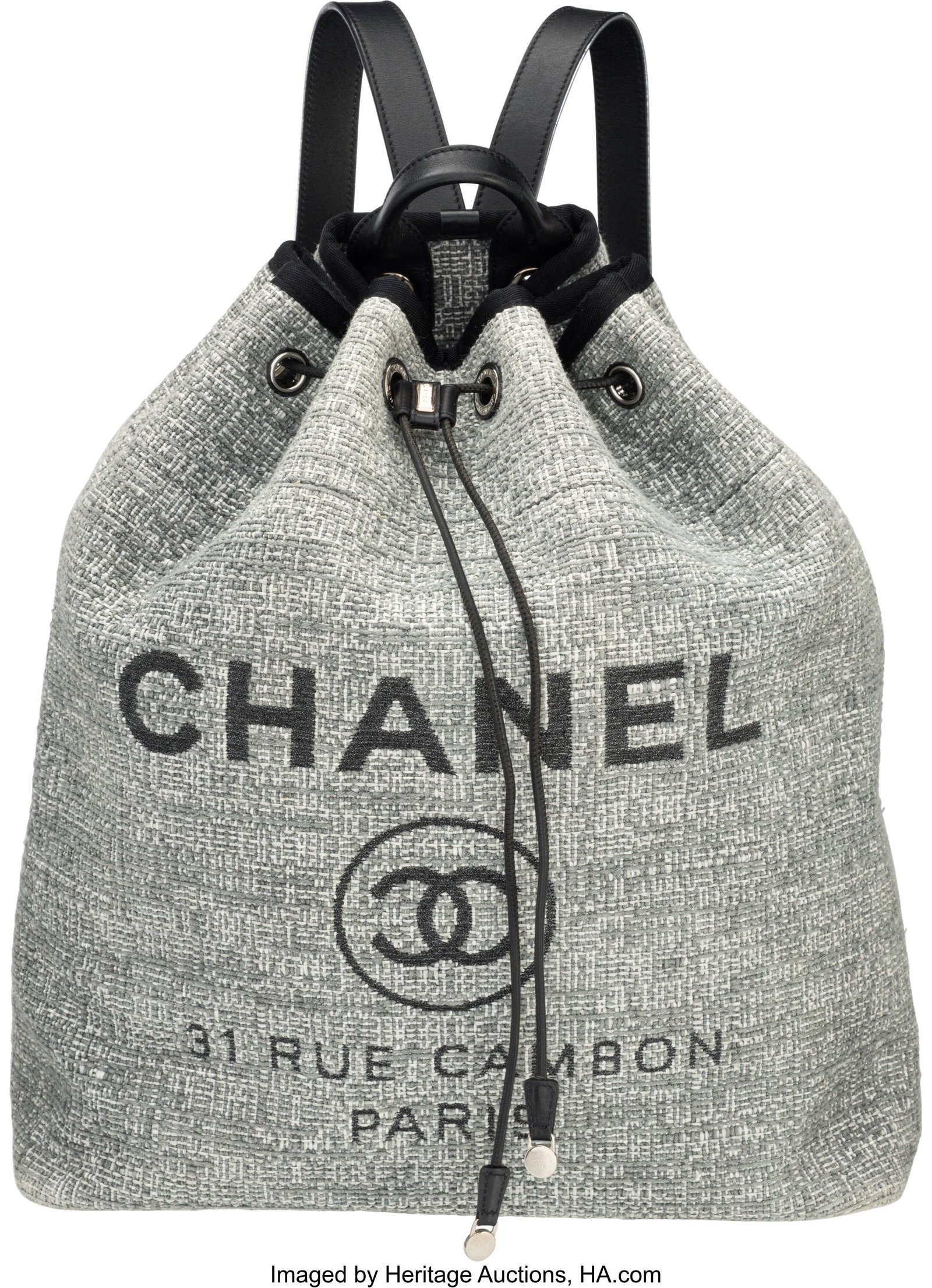 Chanel Gray Tweed Deauville Backpack with Silver: Chanel Gray Tweed Deauville Backpack with Silver Hardware 2018 Condition: 2 11.5" Width x 13.5" Height x 5" Depth This backpack is done in Gray Tweed with Black Leather Trim and Si