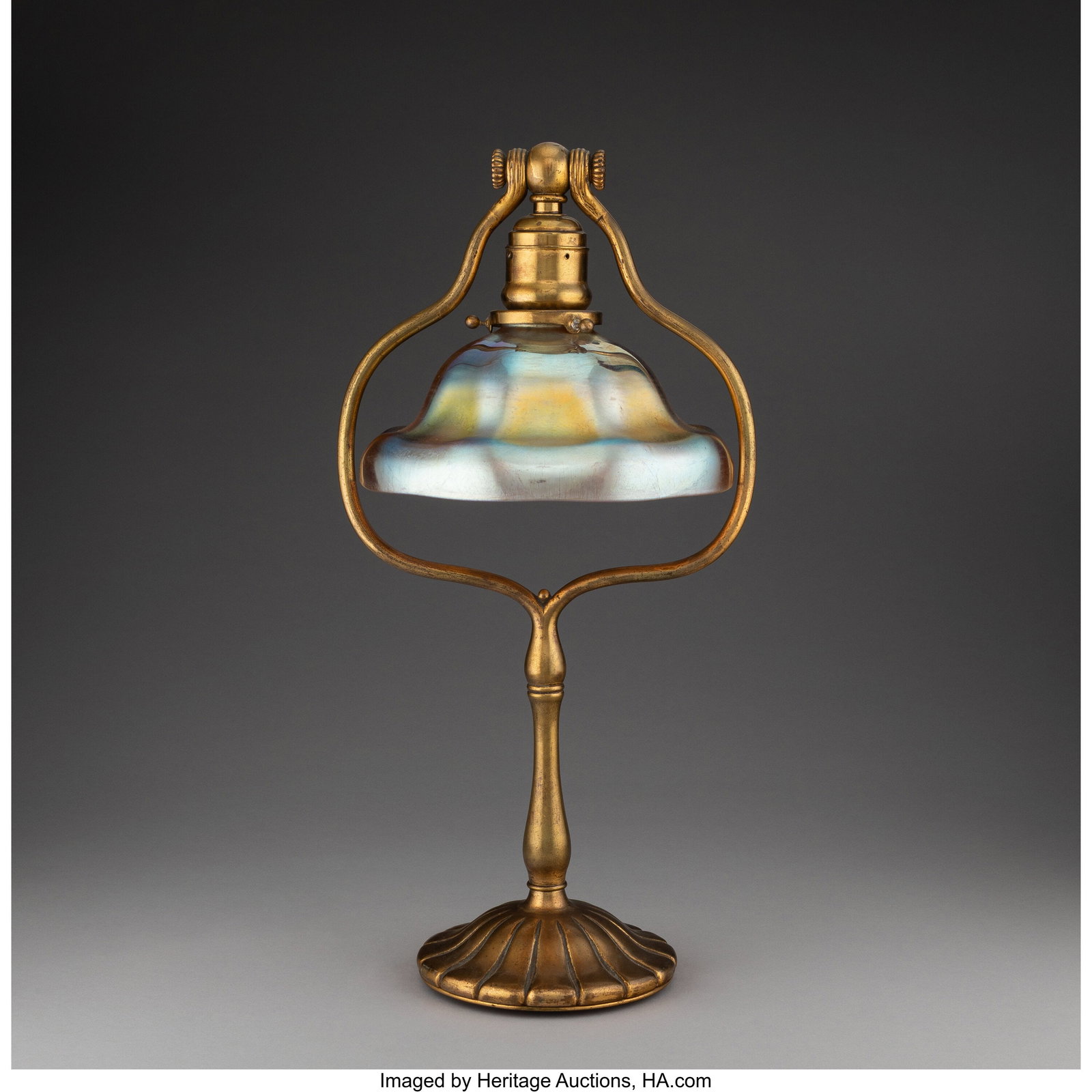 Tiffany Studios Table Lamp, circa 1910 Gilt bron: Tiffany Studios Table Lamp, circa 1910 Gilt bronze, Favrile glass 18 x 9 x 7-7/8 inches (45.7 x 22.9 x 20.0 cm) (overall) Marks to shade: