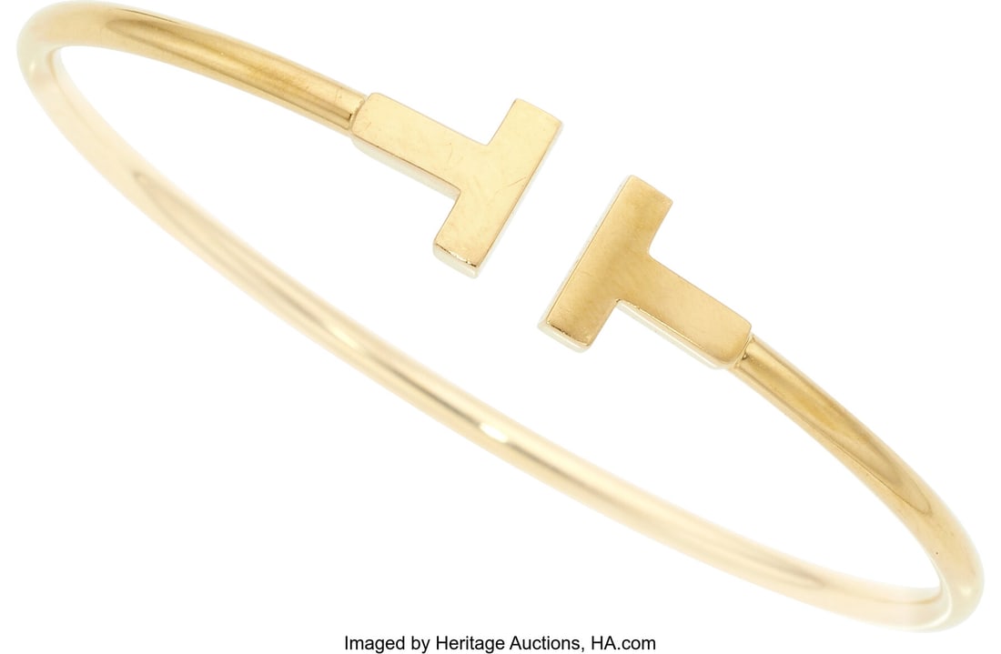 Tiffany & Co. Gold Bracelet Metal: 18k gold Mar: Tiffany & Co. Gold Bracelet Metal: 18k gold Marked: T&Co. Collection: Tiffany T Weight: 8.70 grams Dimensions: 6-1/4 inches x 3/8 inc