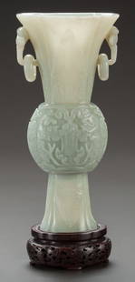 A CHINESE CARVED HARDSTONE GU VASE China, Qing: A CHINESE CARVED HARDSTONE GU VASE China, Qing Dynasty10-1/2 inches high (26.7 cm