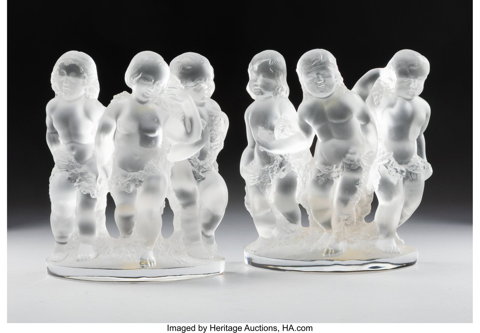 Lalique Pair of Luxembourg Figural Bookends, pos: Lalique Pair of Luxembourg Figural Bookends, post-1945 Clear and frosted glass 8 inches (20.3 cm) (each) Marks: Lalique France Property from the Estate of M