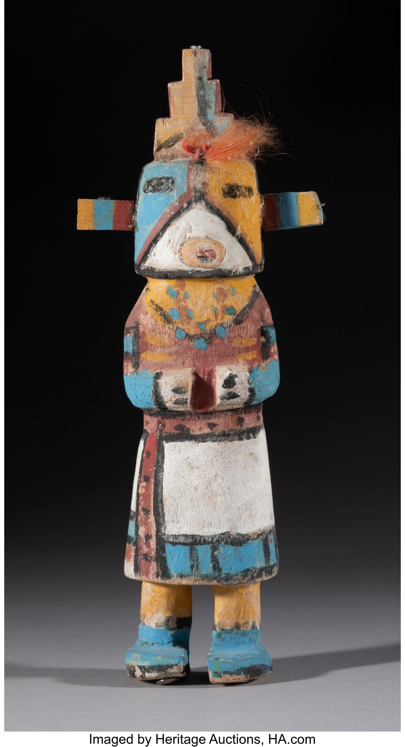 A Hopi Katsina Doll Wilson Tawaquaptewa c. 1949: A Hopi Katsina Doll Wilson Tawaquaptewa c. 1949 cottonwood, pigments, dyed fiber This lot is accompanied by three photographs of Chief Wilson Tawaquaptewa and his granddaughter as w