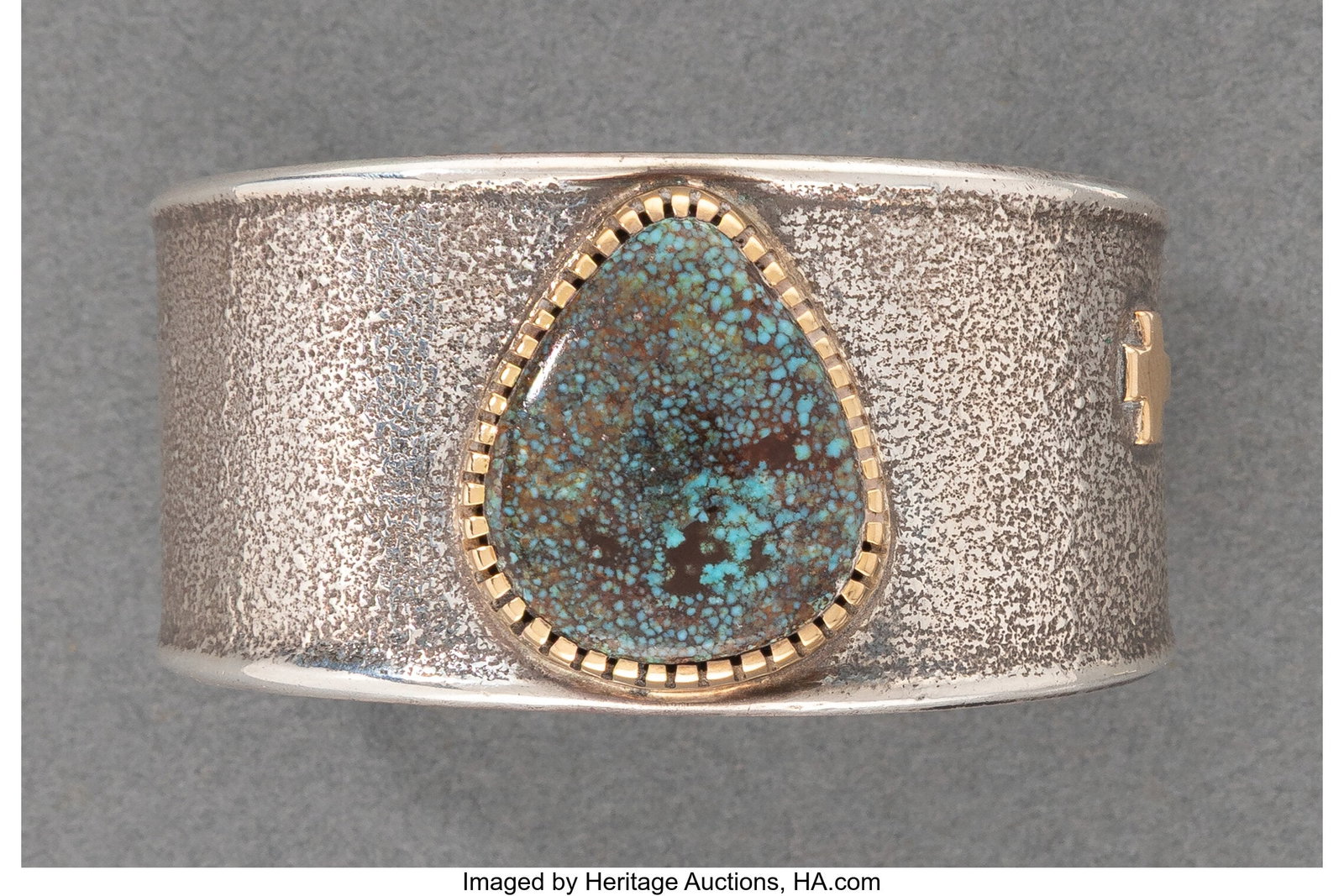 A Hopi Cuff Bracelet Verma Nequatewa (Sonwai) : A Hopi Cuff Bracelet Verma Nequatewa (Sonwai) c. 1990 signed Sonwai, silver, gold, turquoise Width: 2 &frac14; inches HID03101062020 © 2026 Herit