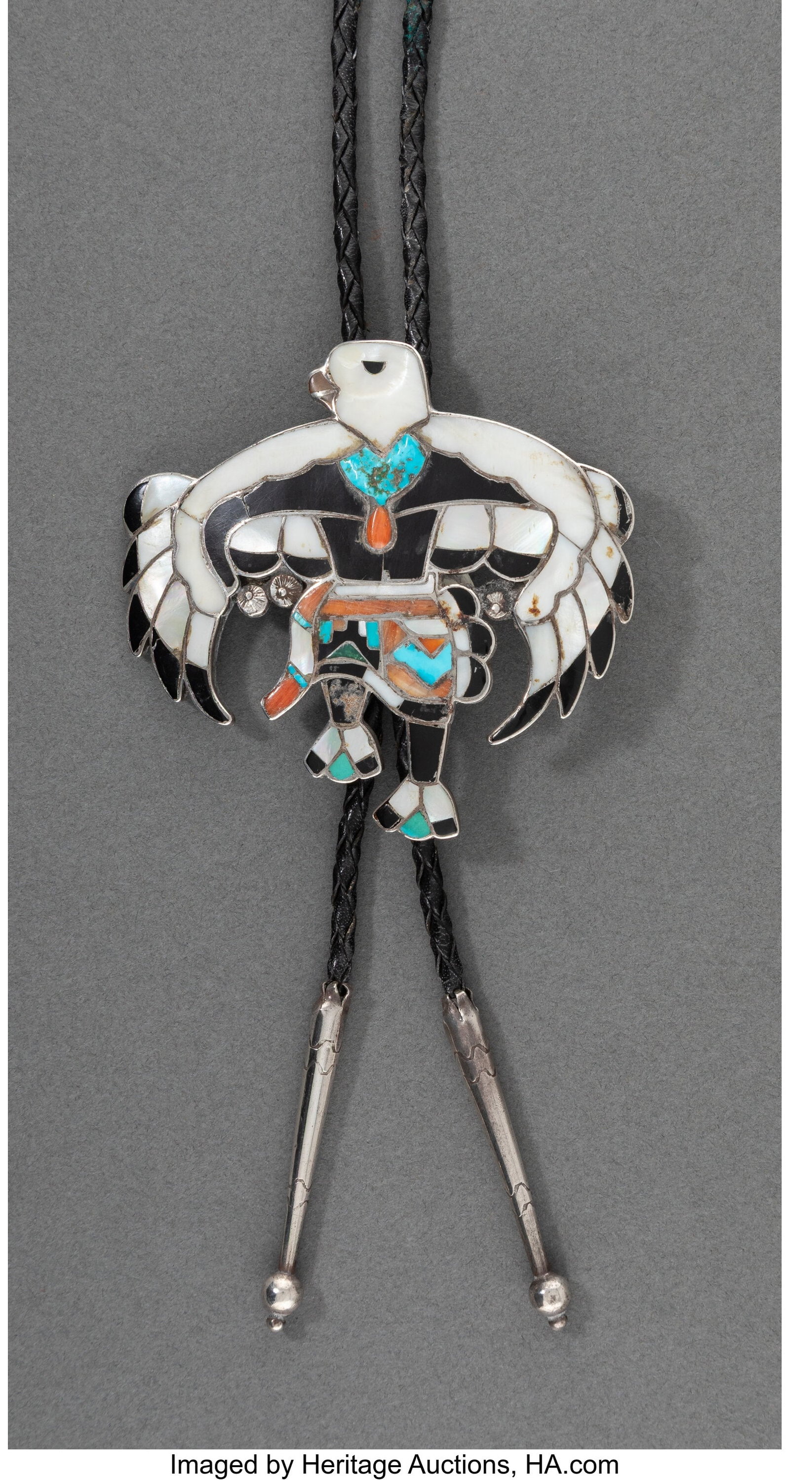 A Zuni Bolo Tie c. 1960 silver, turquoise, jet: A Zuni Bolo Tie c. 1960 silver, turquoise, jet, spiny oyster shell, mother of pearl, shell, coral Height of slide: 3 &frac14; inches HID031010