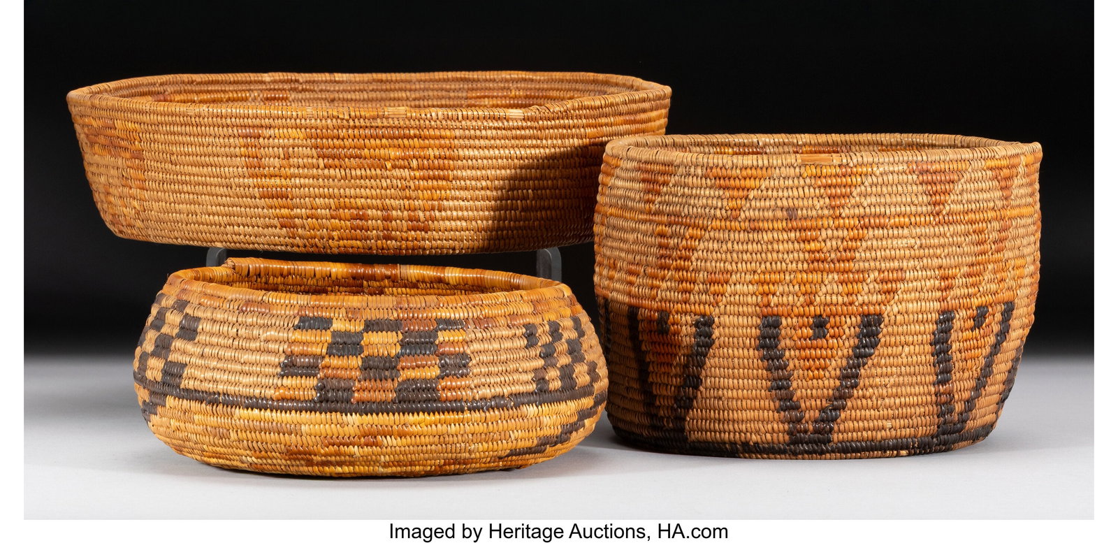 Three Mission Coiled Basketry Items c. 1920 na: Three Mission Coiled Basketry Items c. 1920 natural and dyed sumac, juncas Diameters: ranging from 7 to 10 inches HID03101062020 © 2026 Heritage Auctions | All Rights