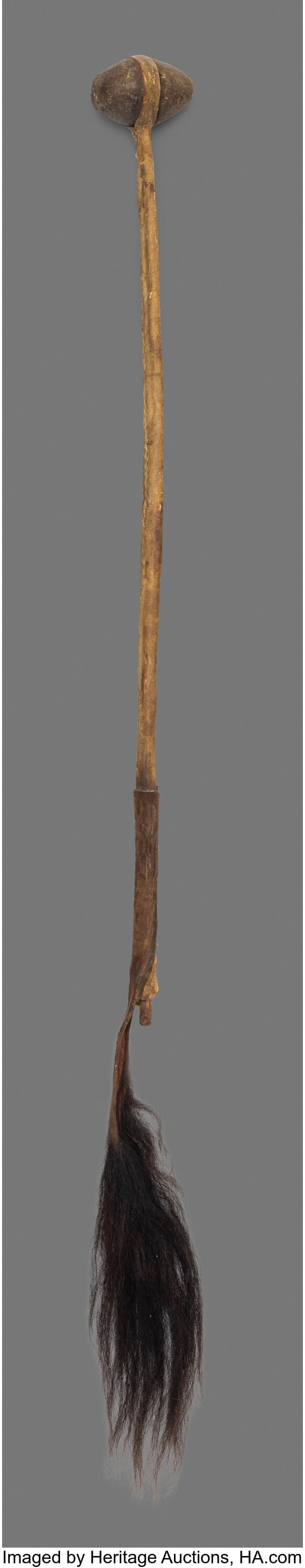 A Plains War Club c. 1870 stone, wood, hide, s: A Plains War Club c. 1870 stone, wood, hide, sinew, horse hair Height: 31 &frac12; inches, excluding hair drop HID03101062020 © 2026 Heritage