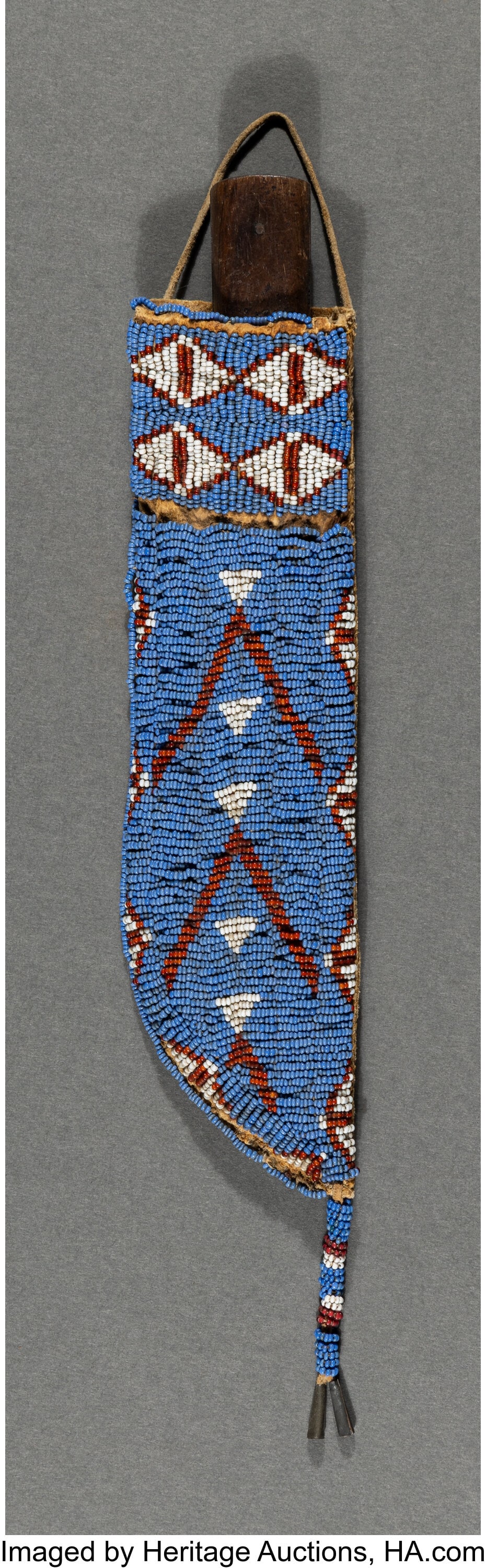 A Sioux Beaded Hide Knife Sheath and Knife c. 1: A Sioux Beaded Hide Knife Sheath and Knife c. 1890 hide, pigments, glass seed beads, metal cones, sinew; wood, metal Length of sheath: 9 &frac12&sem