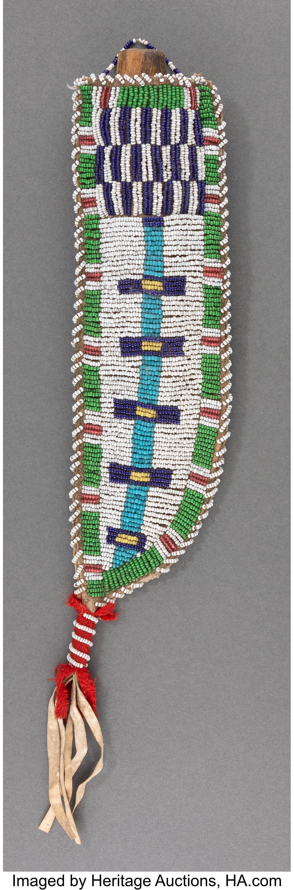A Sioux Beaded Hide Knife Sheath and Knife c. 1: A Sioux Beaded Hide Knife Sheath and Knife c. 1900 hide, yellow ochre pigment, glass seed beads, red wool trade cloth, sinew; wood, metal Provenance: Pr