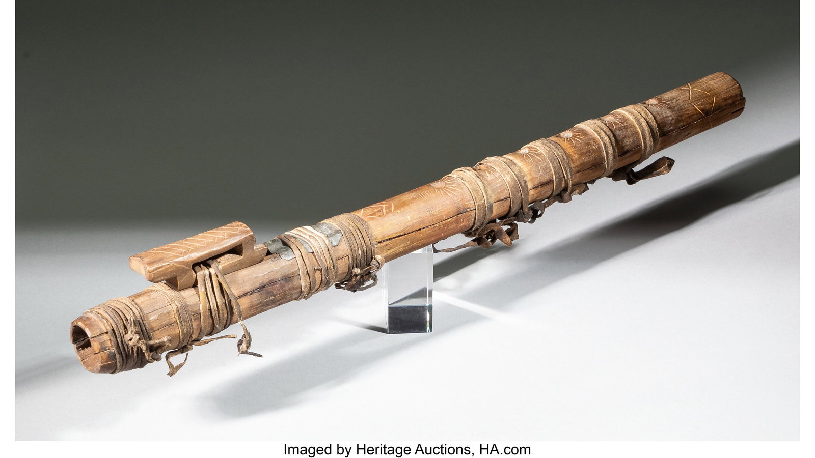 A Plains Courting Flute c. 1870 wood, red pigm: A Plains Courting Flute c. 1870 wood, red pigment, metal, hide Length: 18 inches HID03101062020 © 2026 Heritage Auctions | All Rights Reserved