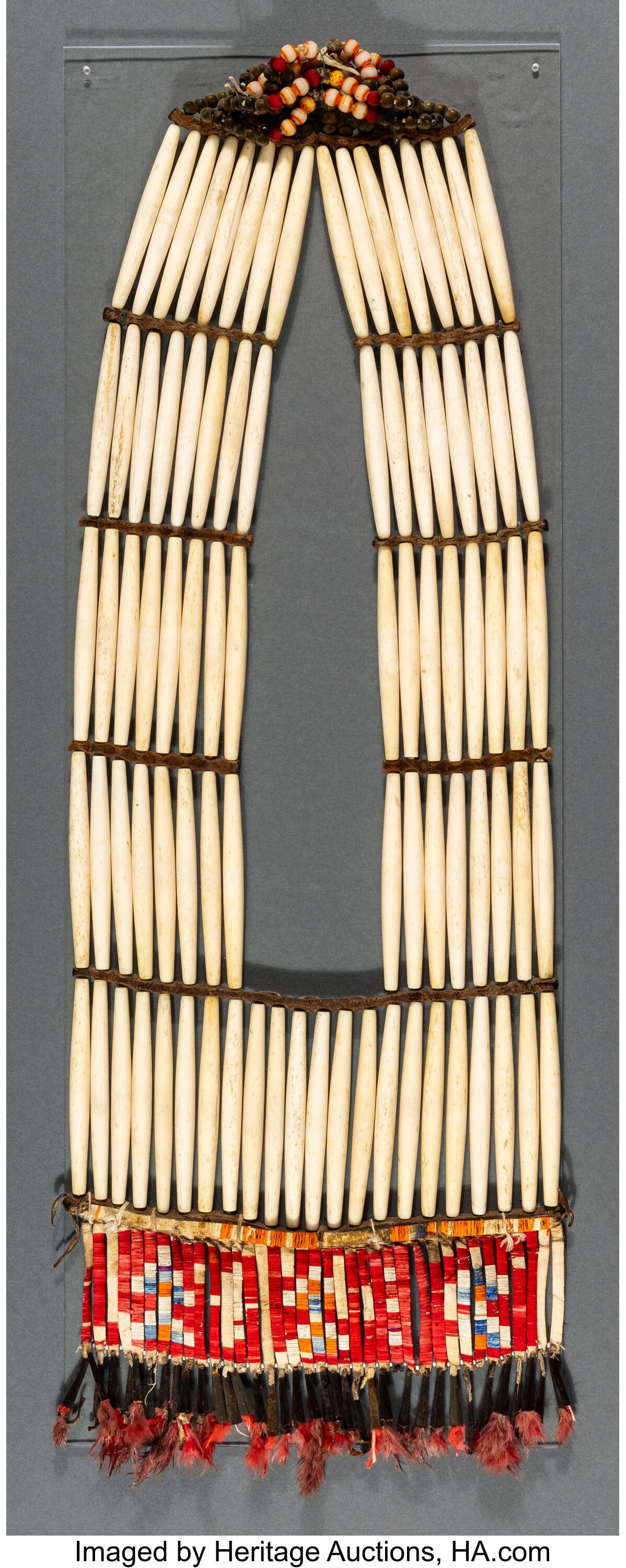 A Sioux Girls' Breastplate c. 1900 bone hairpi: A Sioux Girls' Breastplate c. 1900 bone hairpipe beads, globular brass and glass beads, commercial leather, natural and dyed porcupine quills, metal cones, dyed