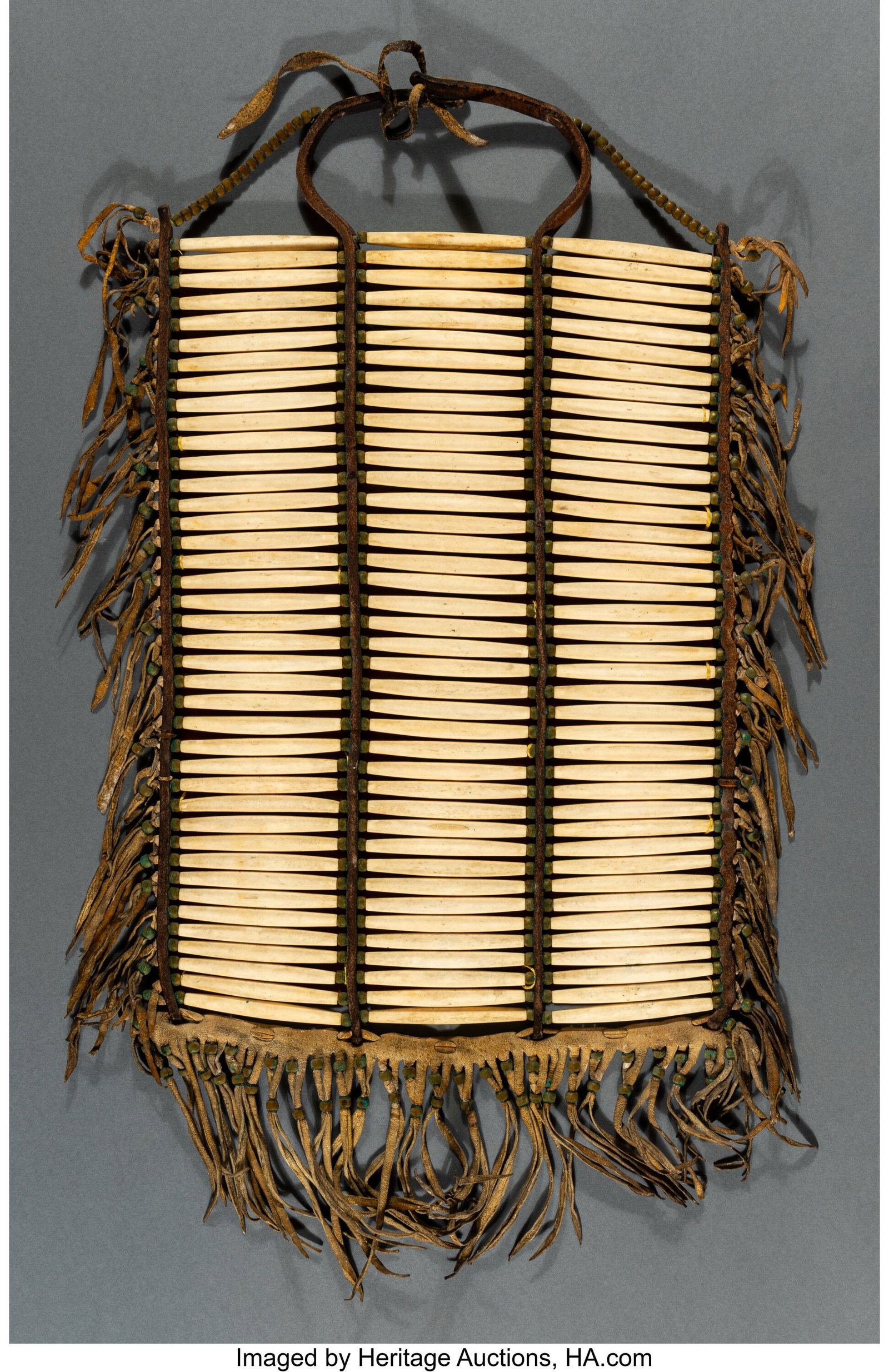 A Plains Man's Breastplate c. 1875 bone hairpi: A Plains Man's Breastplate c. 1875 bone hairpipe beads, globular brass beads, commercial leather, hide Published: Pleasing the Spirits: A Catalogue of a