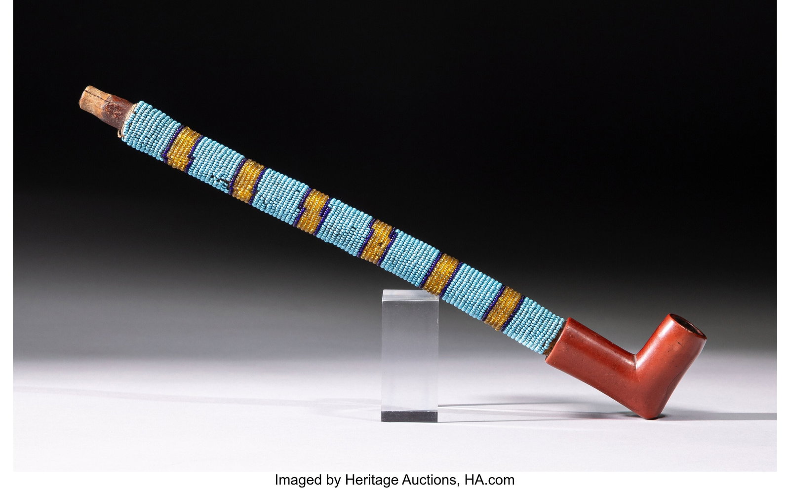 A Plains Woman's Beaded Pipe c. 1890 wood, gla: A Plains Woman's Beaded Pipe c. 1890 wood, glass seed beads, thread, catlinite Length: 10 &frac34; inches HID03101062020 © 2026 Heritage Auctions | Al