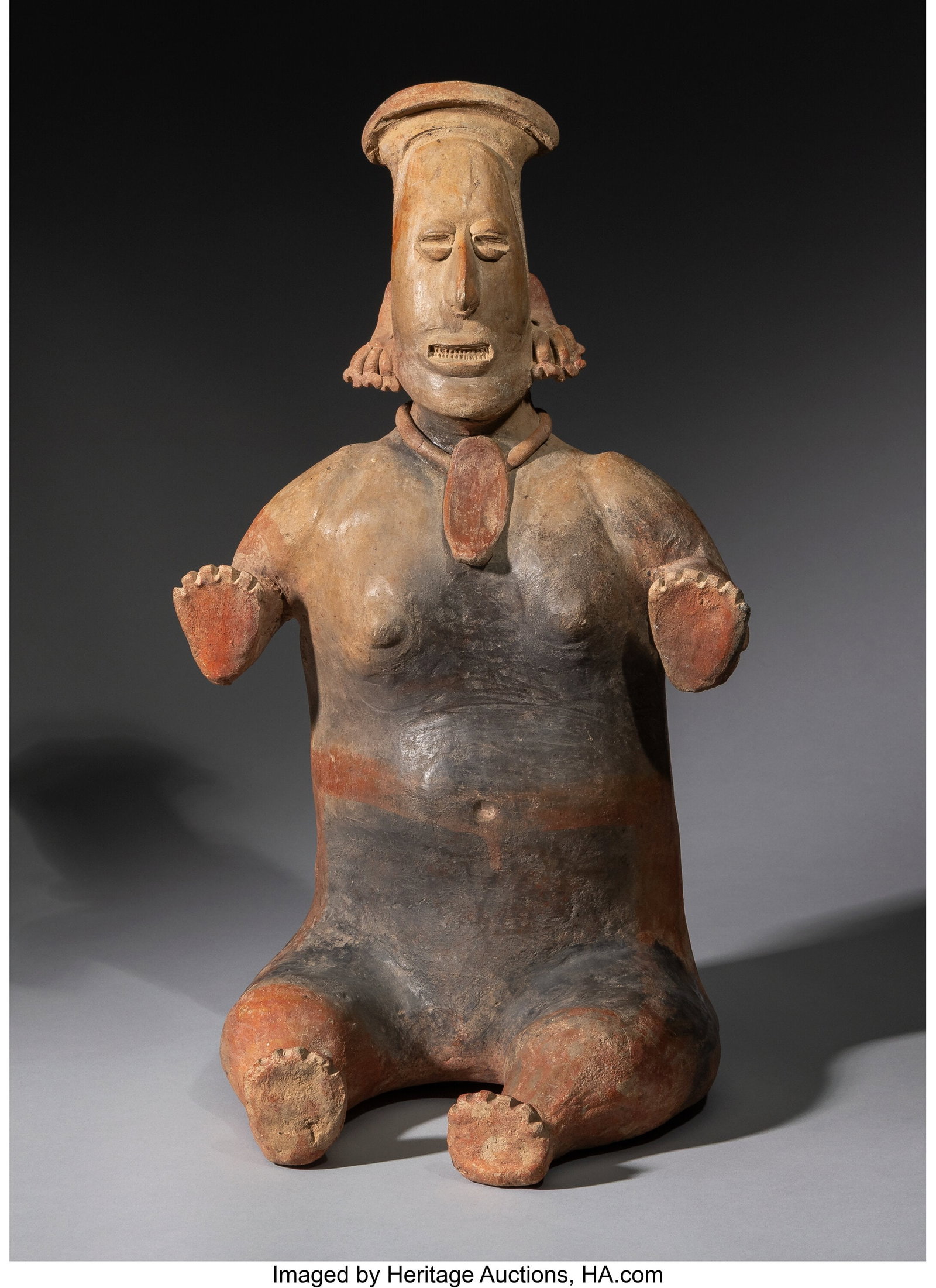 A Large Jalisco Seated Female Figure West Mexic: A Large Jalisco Seated Female Figure West Mexico, c. 250 BC–AD 250 Seated with the legs extended in front, this imposing female figure holds her bent arms at the sides, 