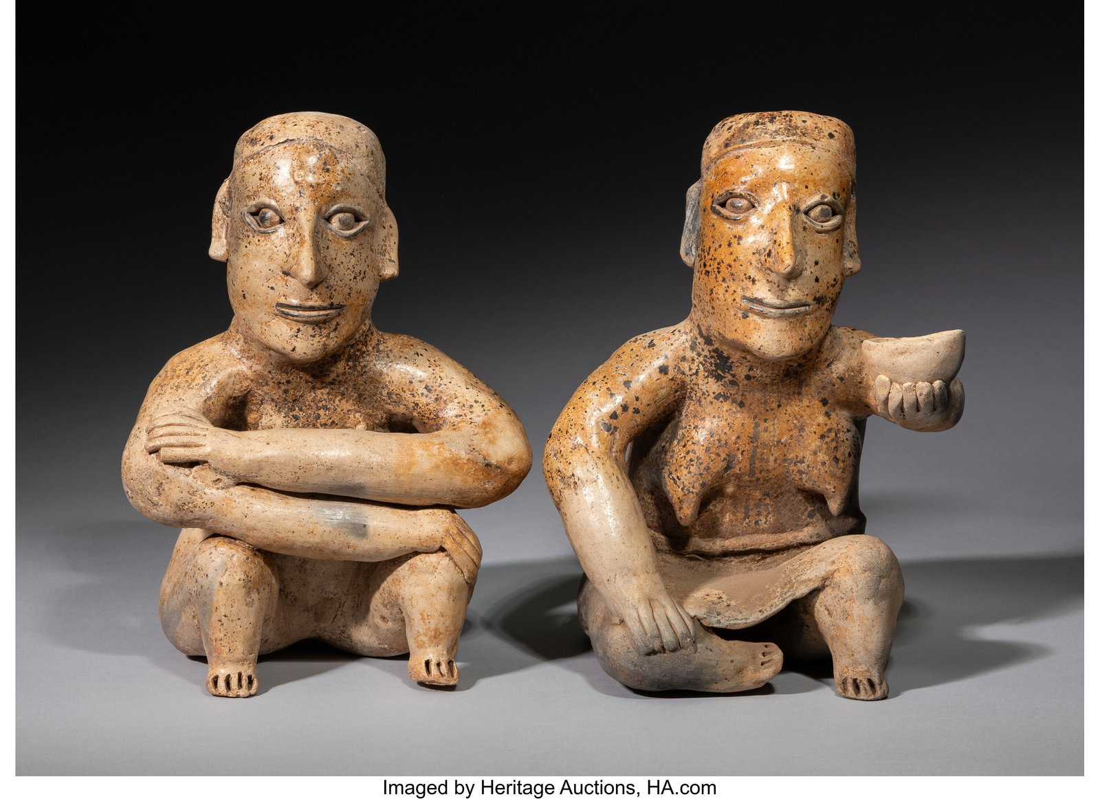 A Pair of Jalisco Figures West Mexico, c. 250 B: A Pair of Jalisco Figures West Mexico, c. 250 BC–250 AD Each hollow ceramic figure is covered with a burnished cream-colored slip, with black pigment accenting the eyes and mo