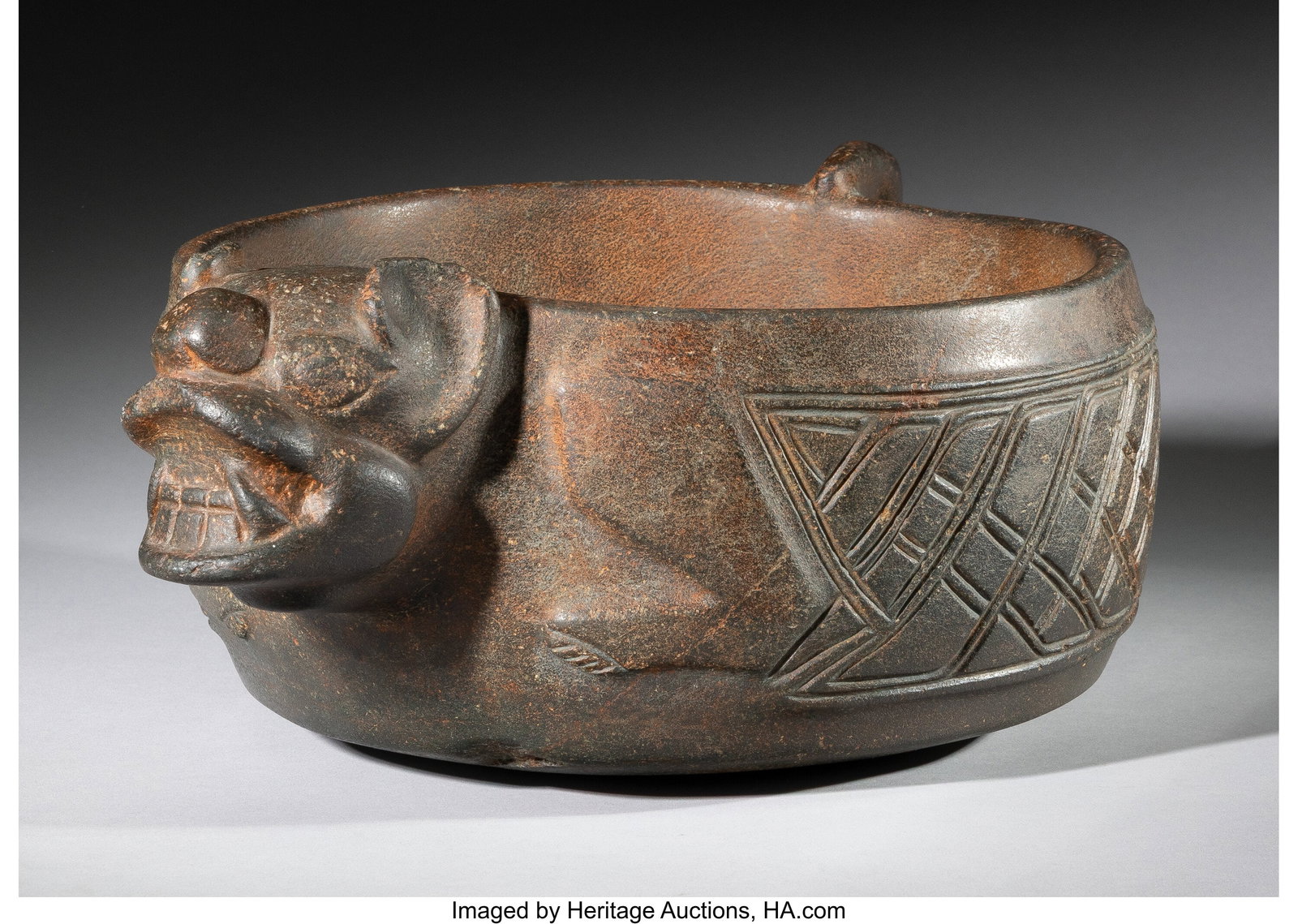 A Magnificent Large Stone Bowl with Jaguar Motif: A Magnificent Large Stone Bowl with Jaguar Motifs Guerrero or nearby Central Mexico, c. 500 BC–200 AD Carved from dense fine-grained hardstone, ranging in tone from dark brown