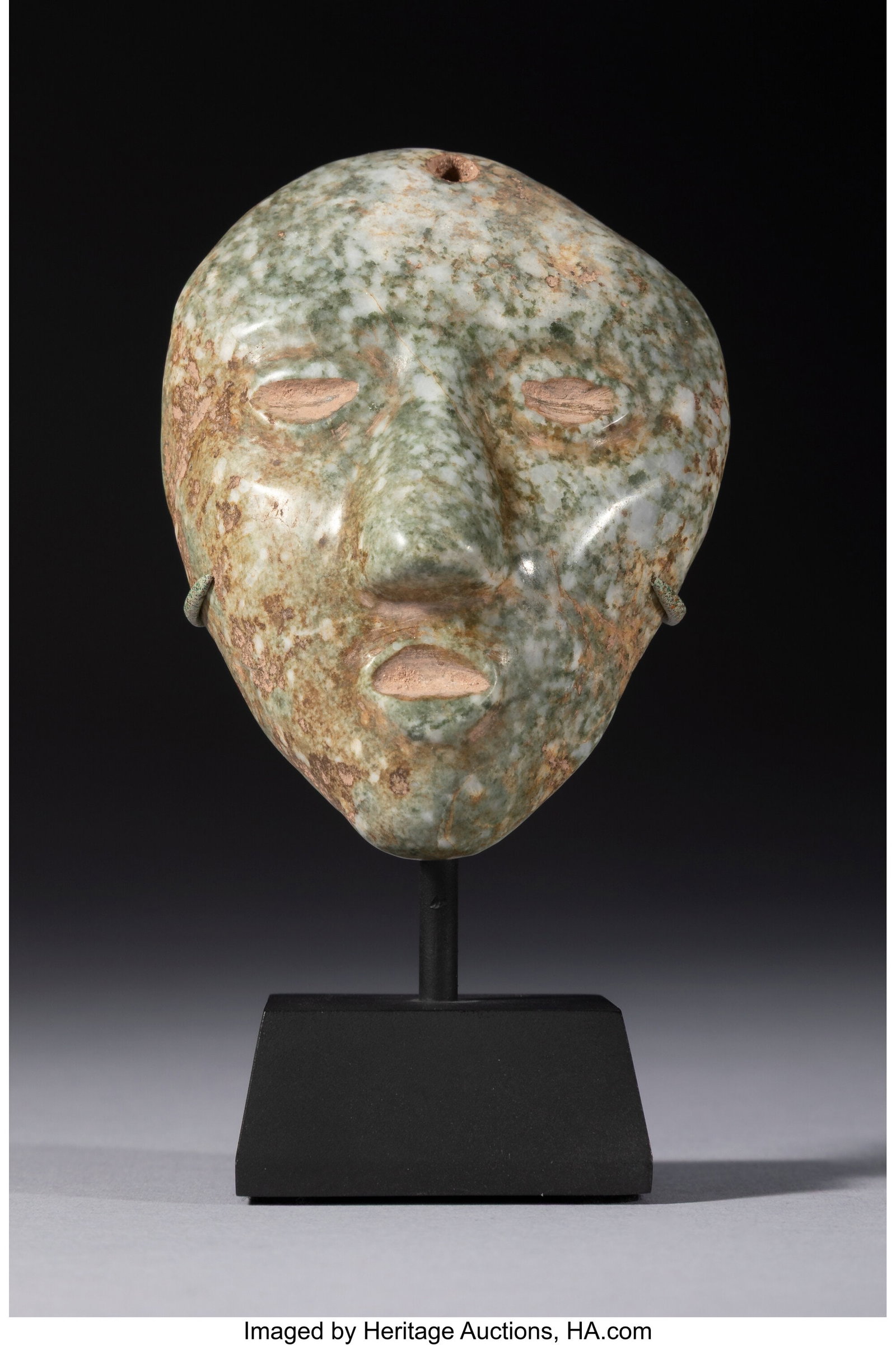 A Small Chontal Head Mexico, c. 500–100 BC S: A Small Chontal Head Mexico, c. 500–100 BC Speckled green and gray jadeite with a smooth, soft hand feel. The head is simply carved, with semicircular incised eye