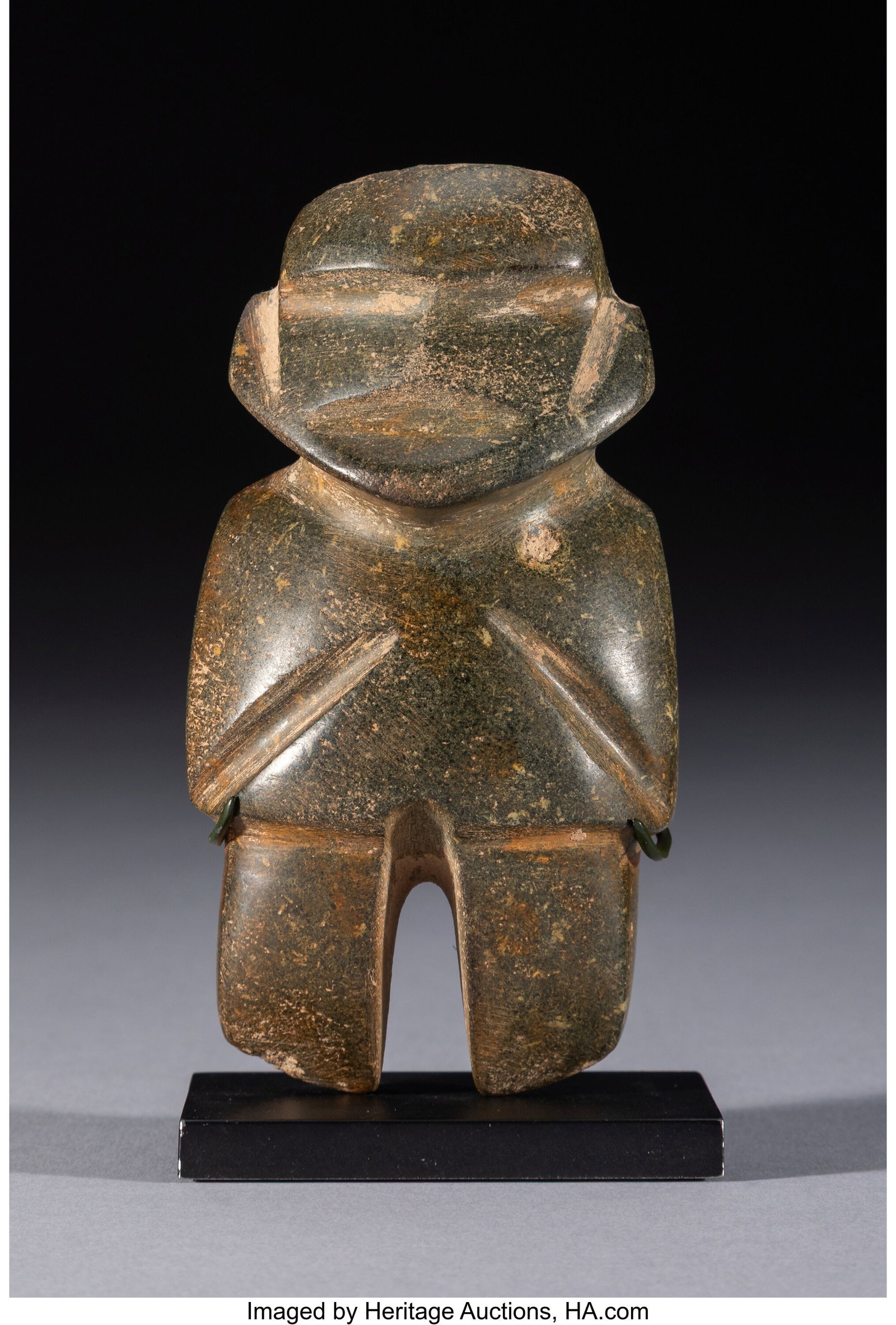 A Mezcala Figure Mexico, c. 300–100 BC A com: A Mezcala Figure Mexico, c. 300–100 BC A compact standing figure of M-8 type, with a broad body and wide head, carved in the abstract manner associated with classic Mezc