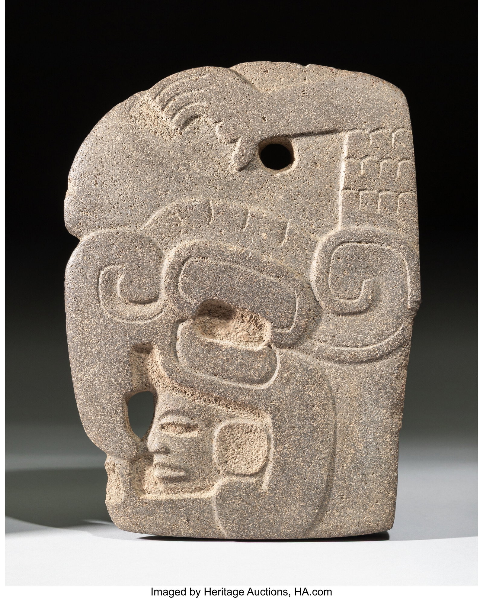A Maya Avian Hacha Gulf Coast, Mexico, c. 600-800 AD: A Maya Avian Hacha Gulf Coast, Mexico, c. 600–800 AD Carved from dense gray stone with a smooth surface, this hacha takes the form of a large bird head with a raptor's beak. The rectangular eye is c