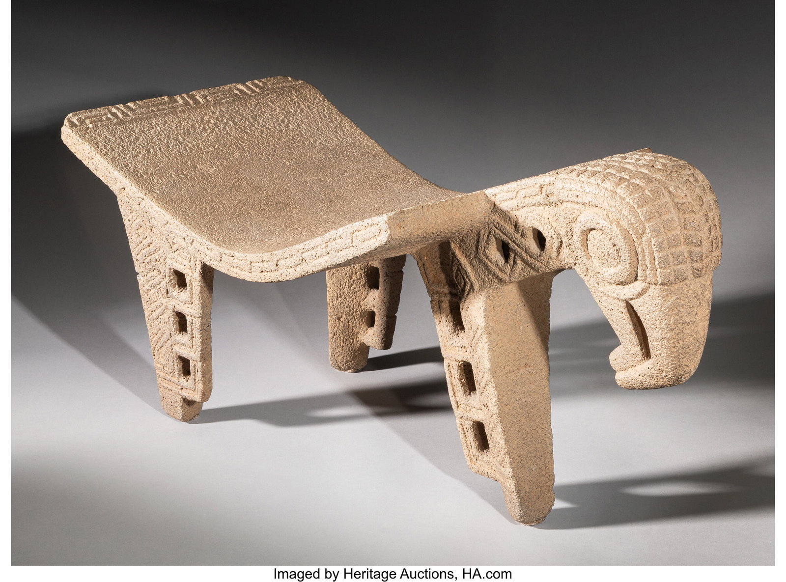 A Diquís Ceremonial Metate Costa Rica, c. 800-1500 AD: A Diquís Ceremonial Metate Costa Rica, c. 800–1500 AD Carved from volcanic stone, this large ceremonial metate is supported on three legs and surmounted at one end by the head of a harpy eagle, its
