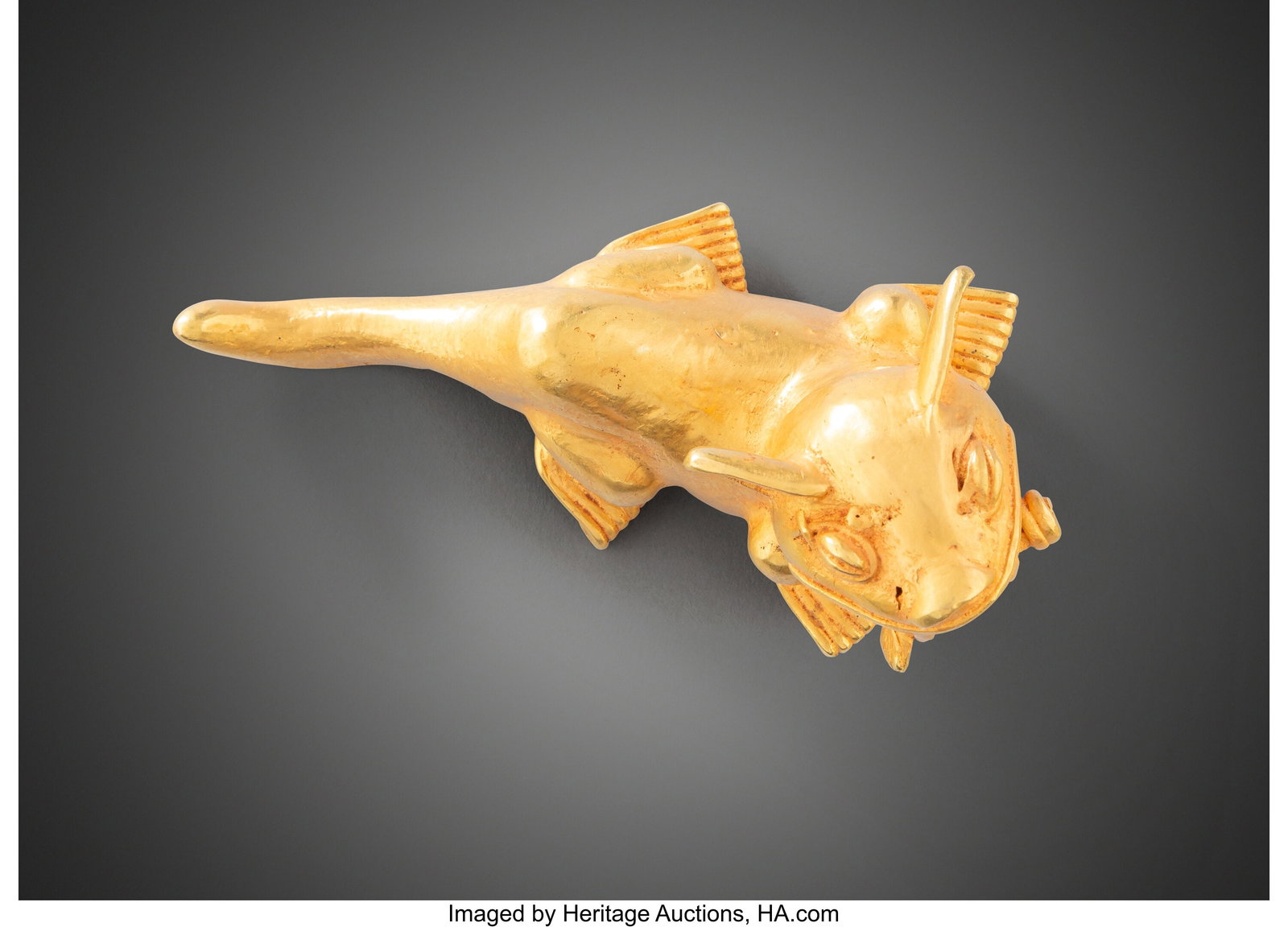A Gold Jaguar Pendant Colombia or Panama, c. 70: A Gold Jaguar Pendant Colombia or Panama, c. 700–1200 AD Hollow cast in tumbaga, this pendant depicts a crouching jaguar grasping a severed human leg in its jaws. The a